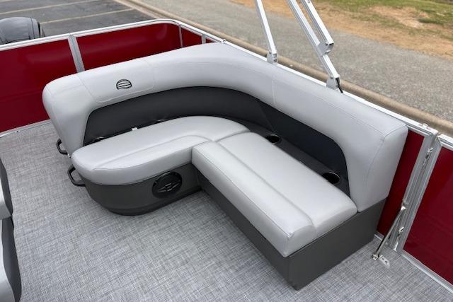 2026 Sun Tracker Party Barge 18 DLX interior with gray seating and cup holders.