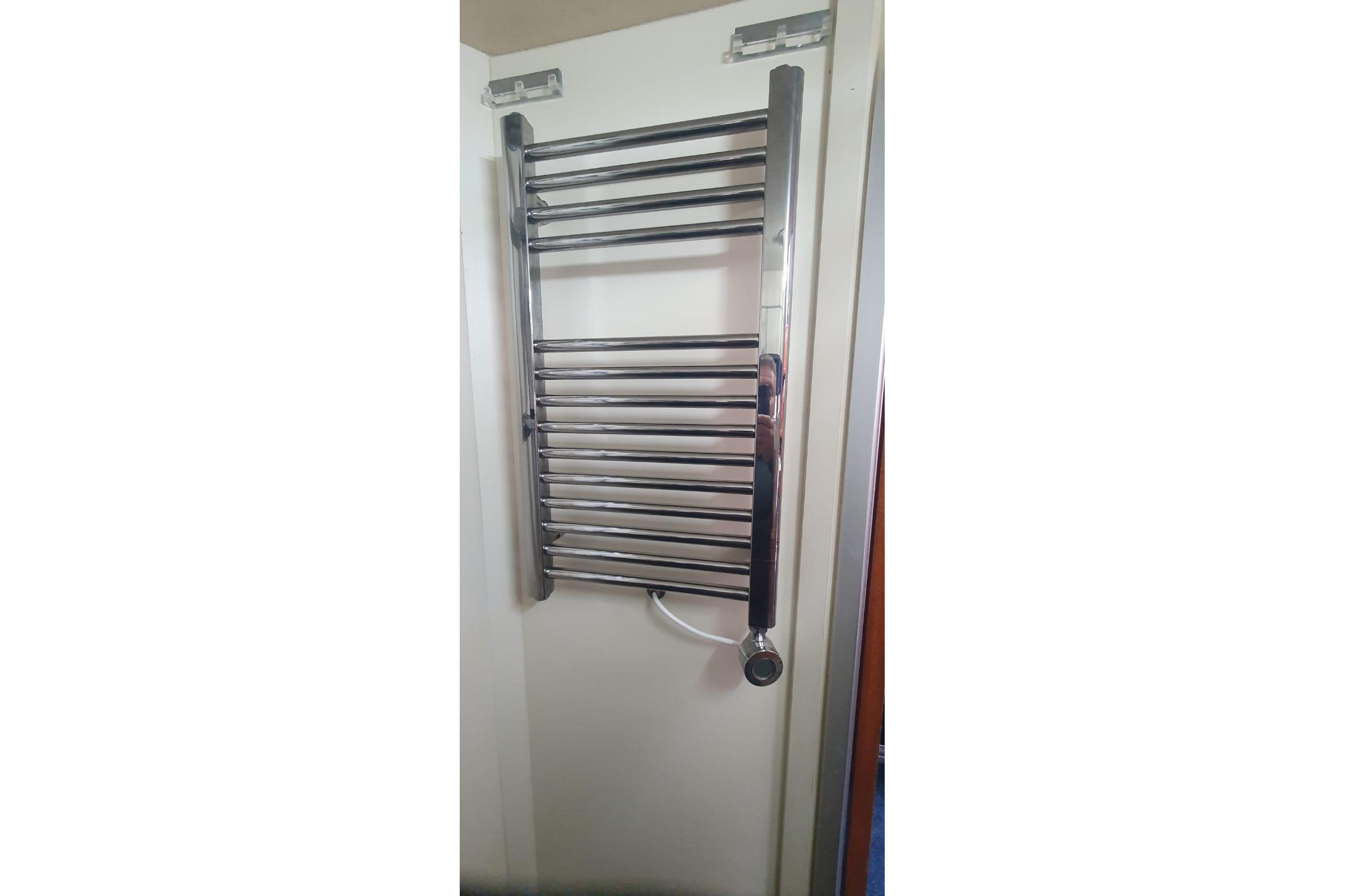 Chrome towel radiator in a bathroom, Princess 35 model, 1989.