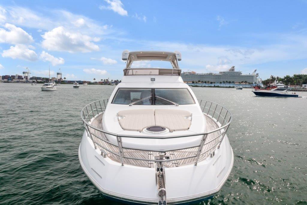 Azimut 64 Flybridge 2014 yacht on open water, clear sky, and distant ships.