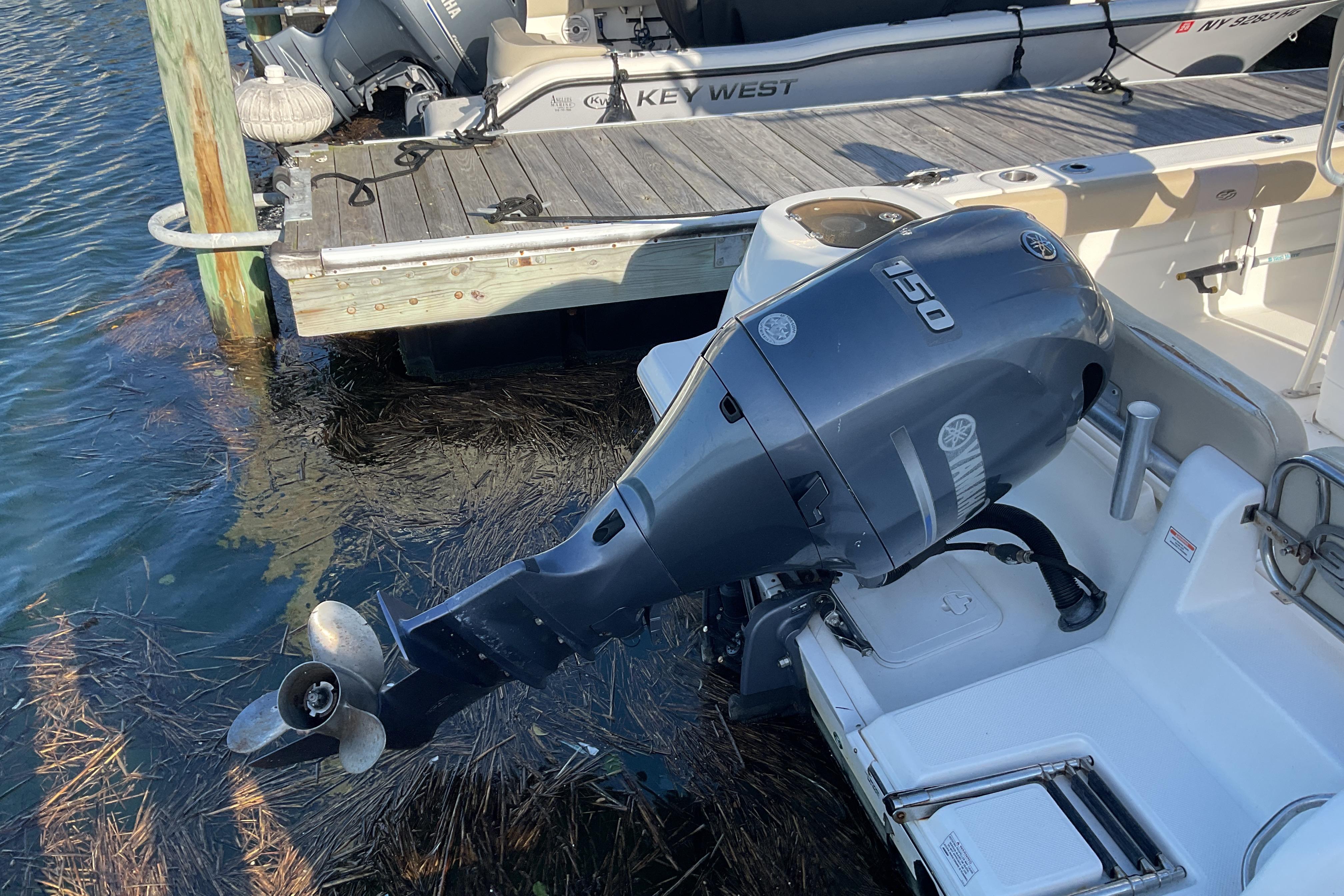 2016 Sea Fox 226 Commander with Yamaha 150 outboard motor docked by pier.