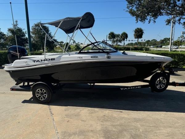 2025 Tahoe 200 S boat on trailer, black and white design, parked outdoors.