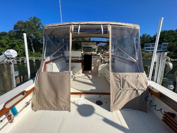 The image shows the cockpit of a 1985 Viking 35 Express with a canopy and clear windows.