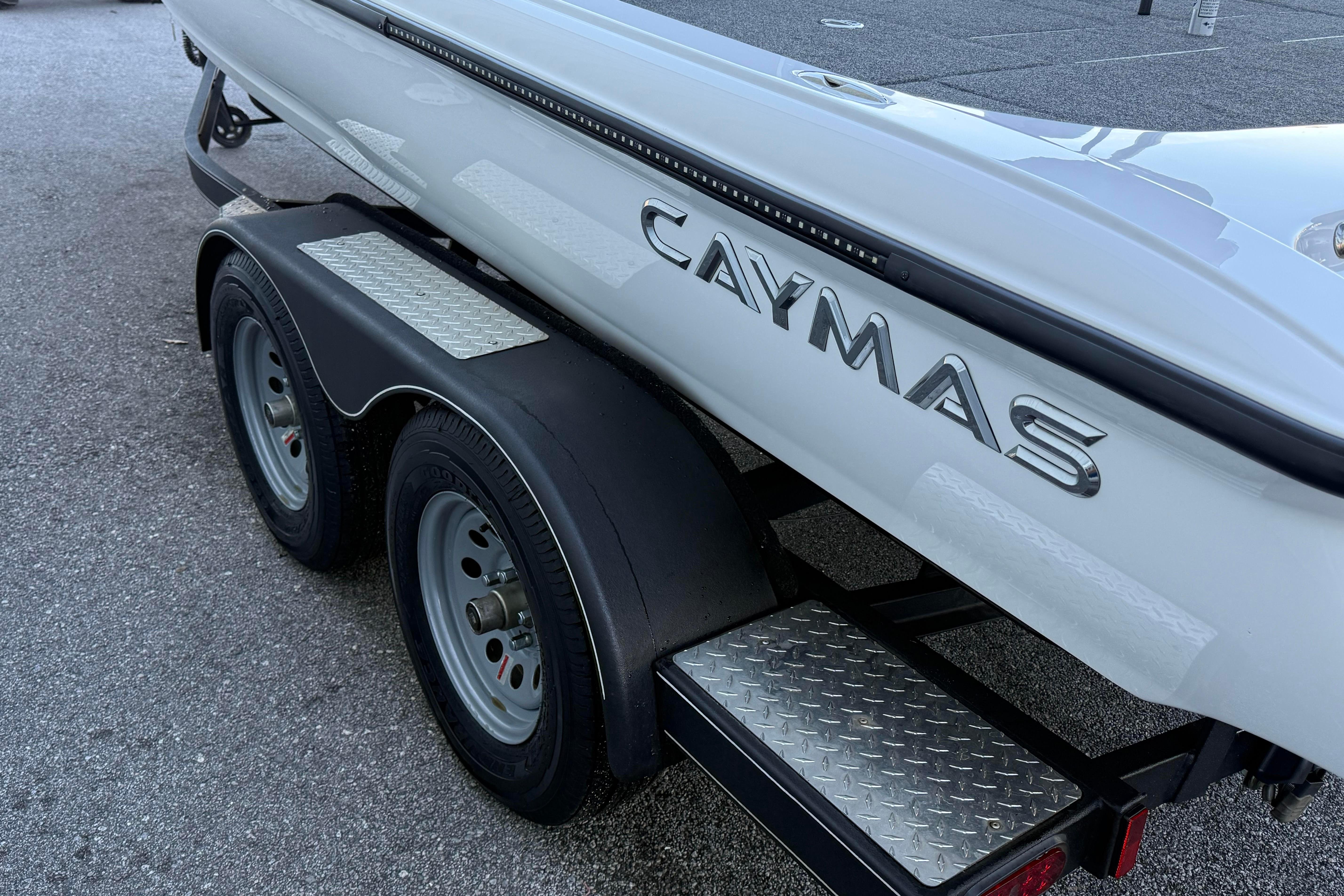 2022 Caymas CX 20 PRO boat on a dual-axle trailer, featuring diamond plate steps.