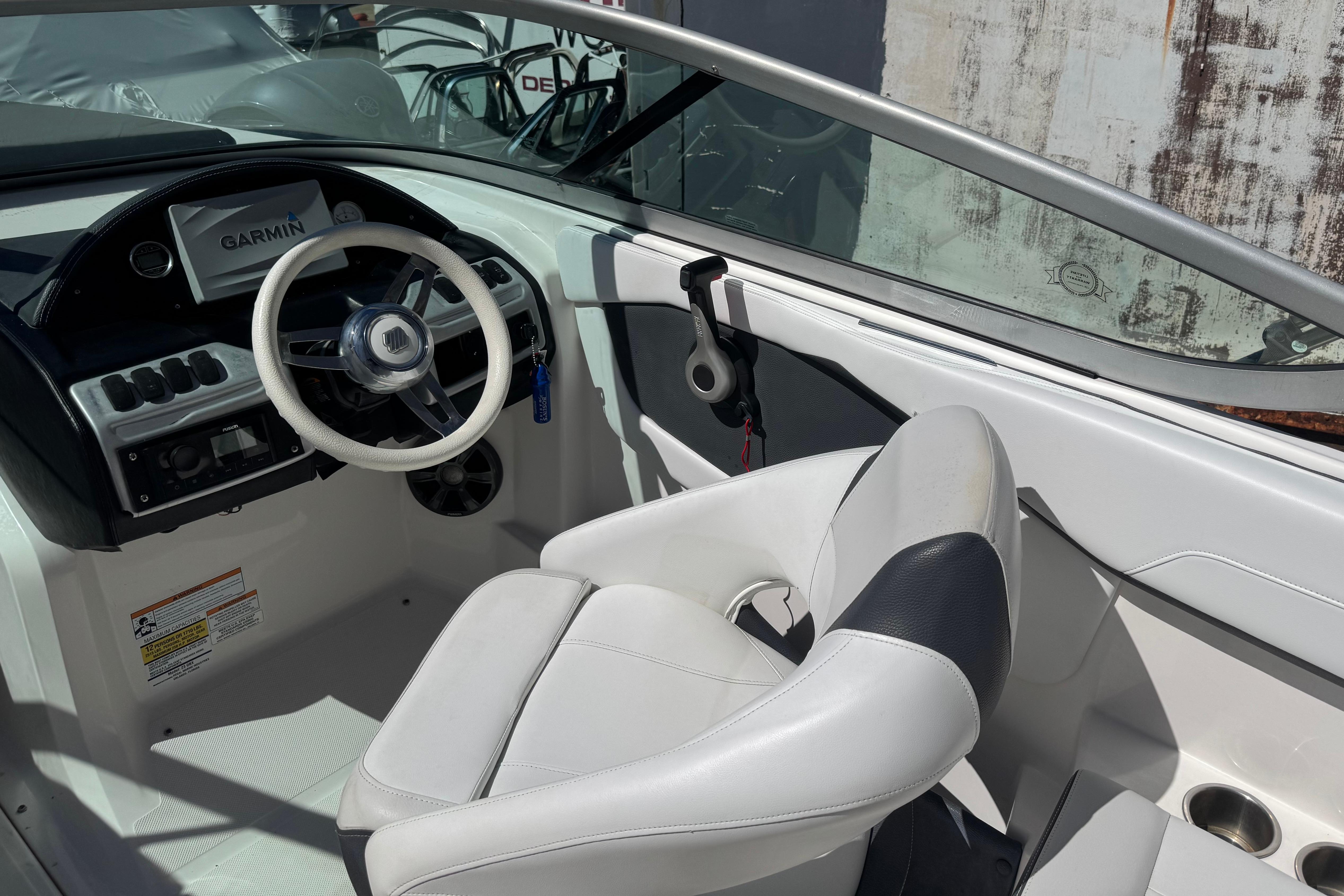 2017 Regal 23 OBX boat cockpit with Garmin navigation system and white seating.