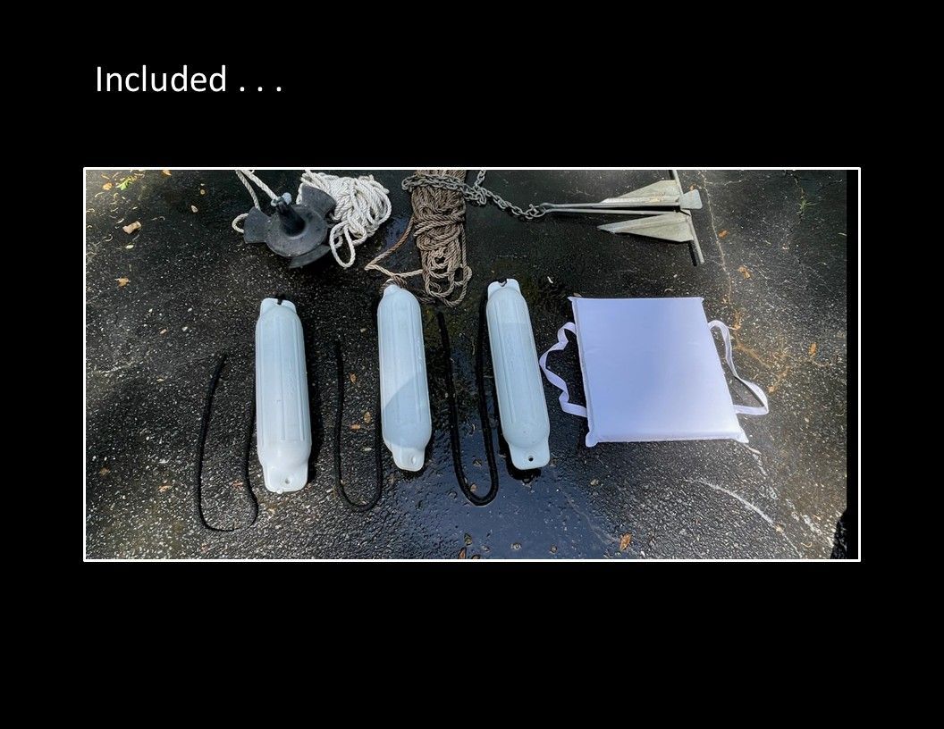 Boat accessories including anchor, fenders, and rope.