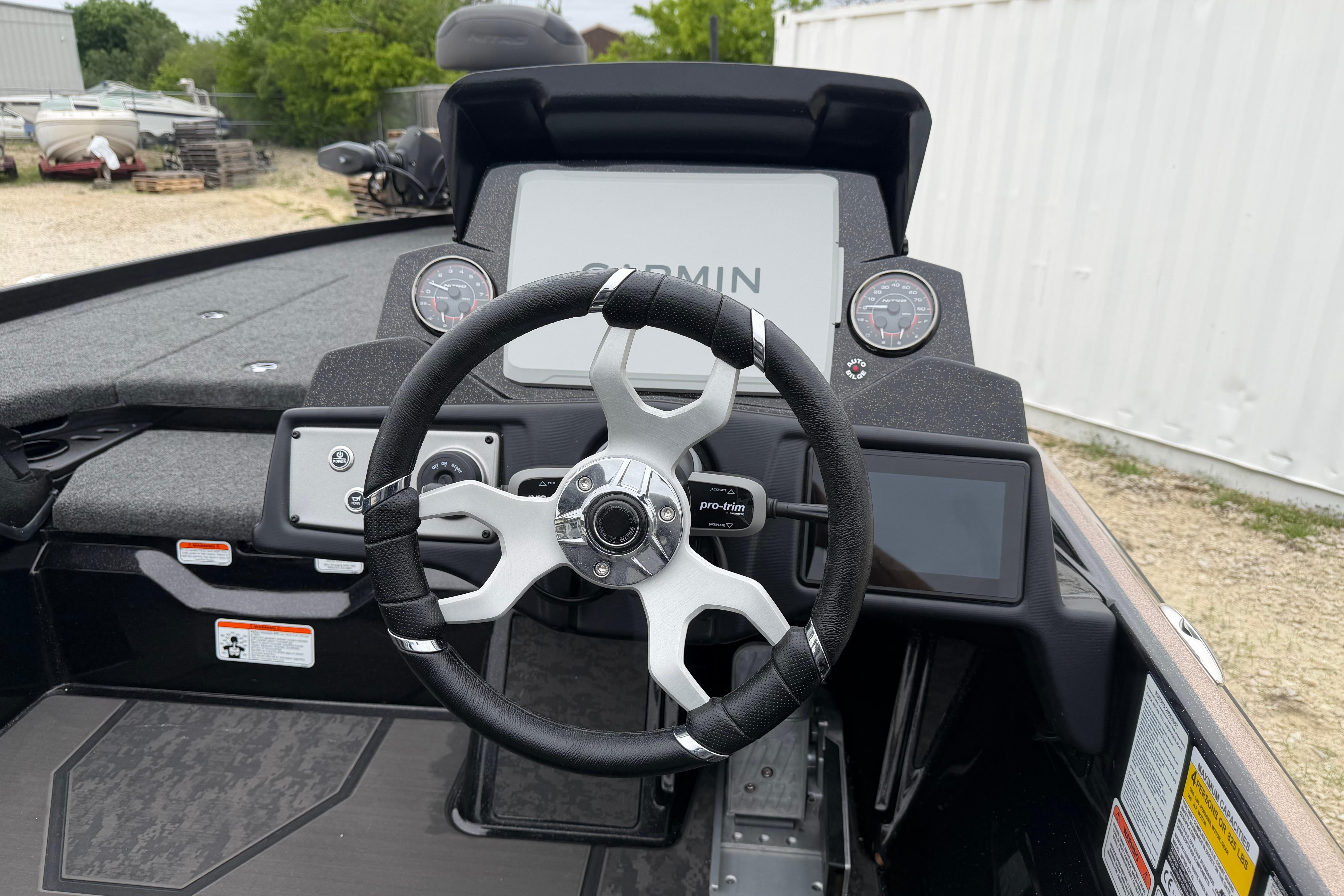 Steering wheel and dashboard of 2026 Nitro Z21 XL Pro boat with Garmin display.