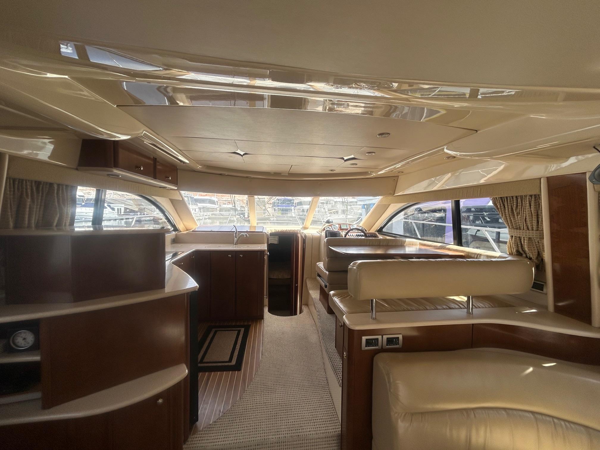 Luxurious interior of a 2005 Meridian Gone Dingy 411 Sedan yacht with elegant wood finishes.