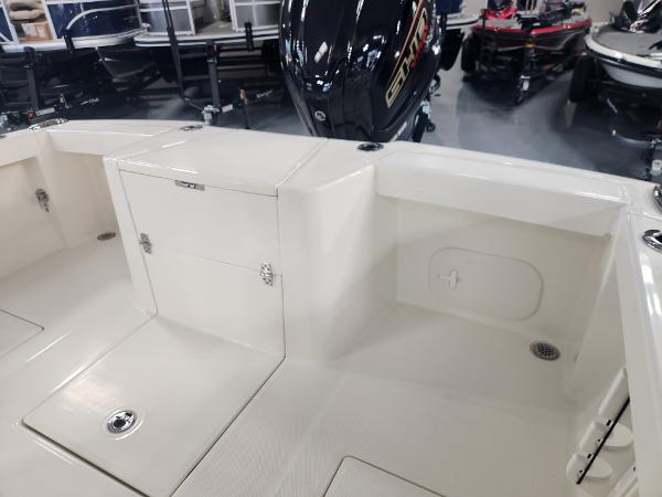 2025 Pathfinder 2400 Open boat interior with storage compartments and outboard motor.