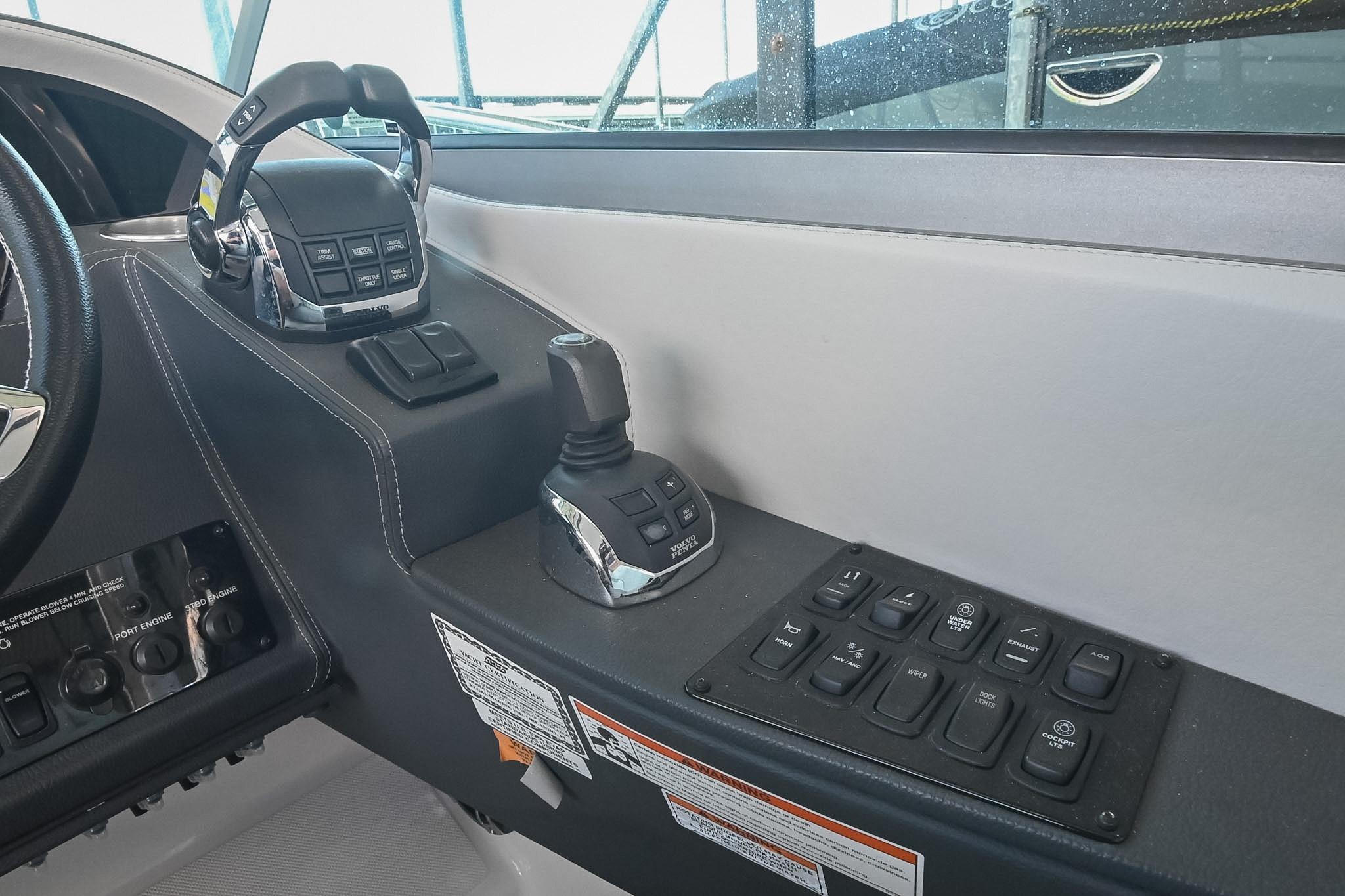 Control panel of a 2021 Regal 33 Express boat with joystick and switches.