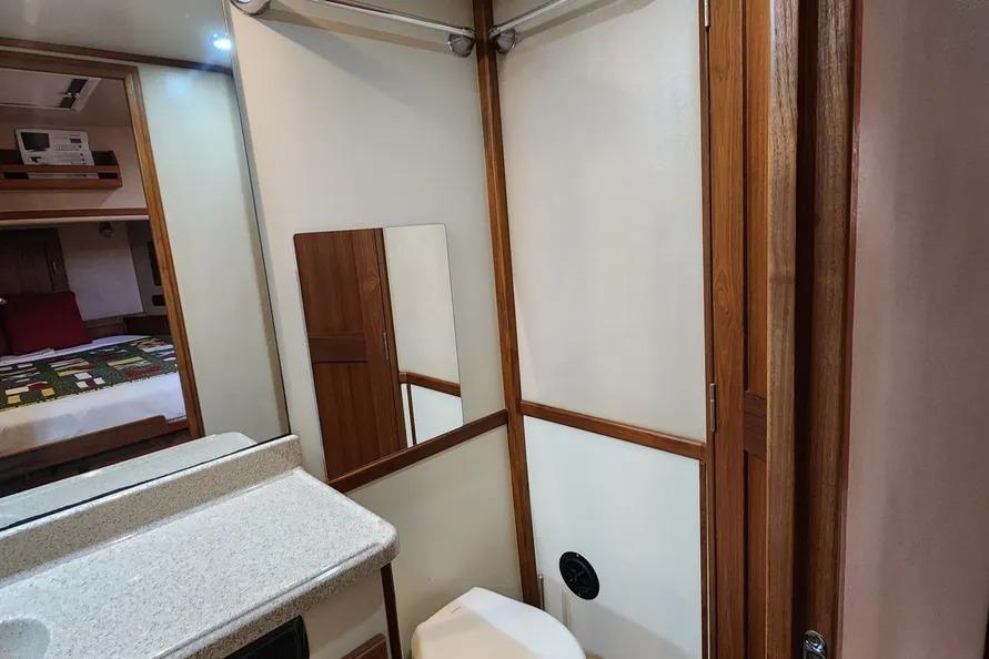 2006 American Tug AT bathroom interior with wood accents and mirror.