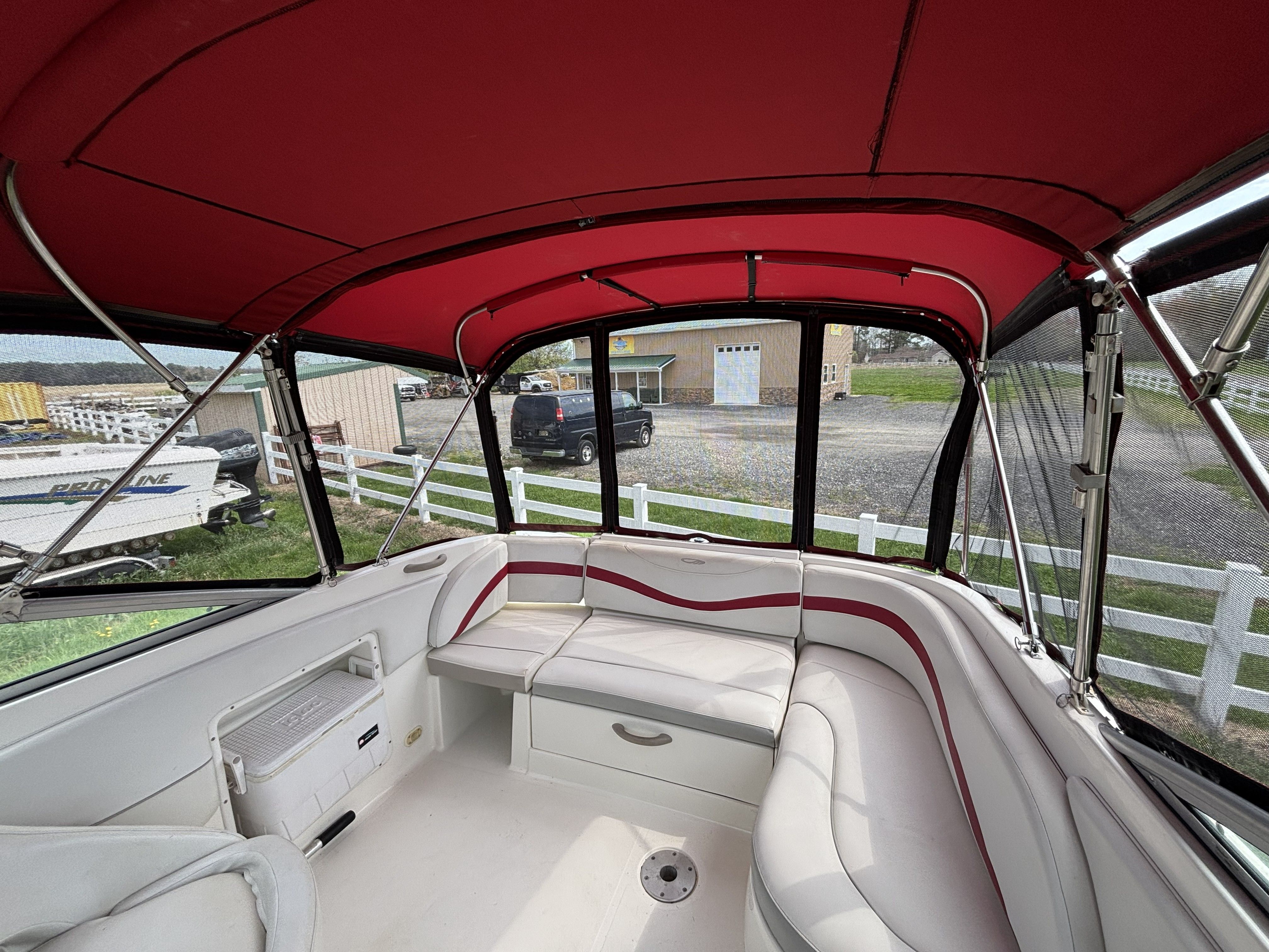 Interior of a 2005 Maxum 2400 SC3 boat with red canopy.