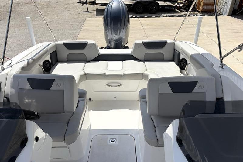 2026 Hurricane SunDeck Sport 2050 OB boat interior with seating and outboard motor.