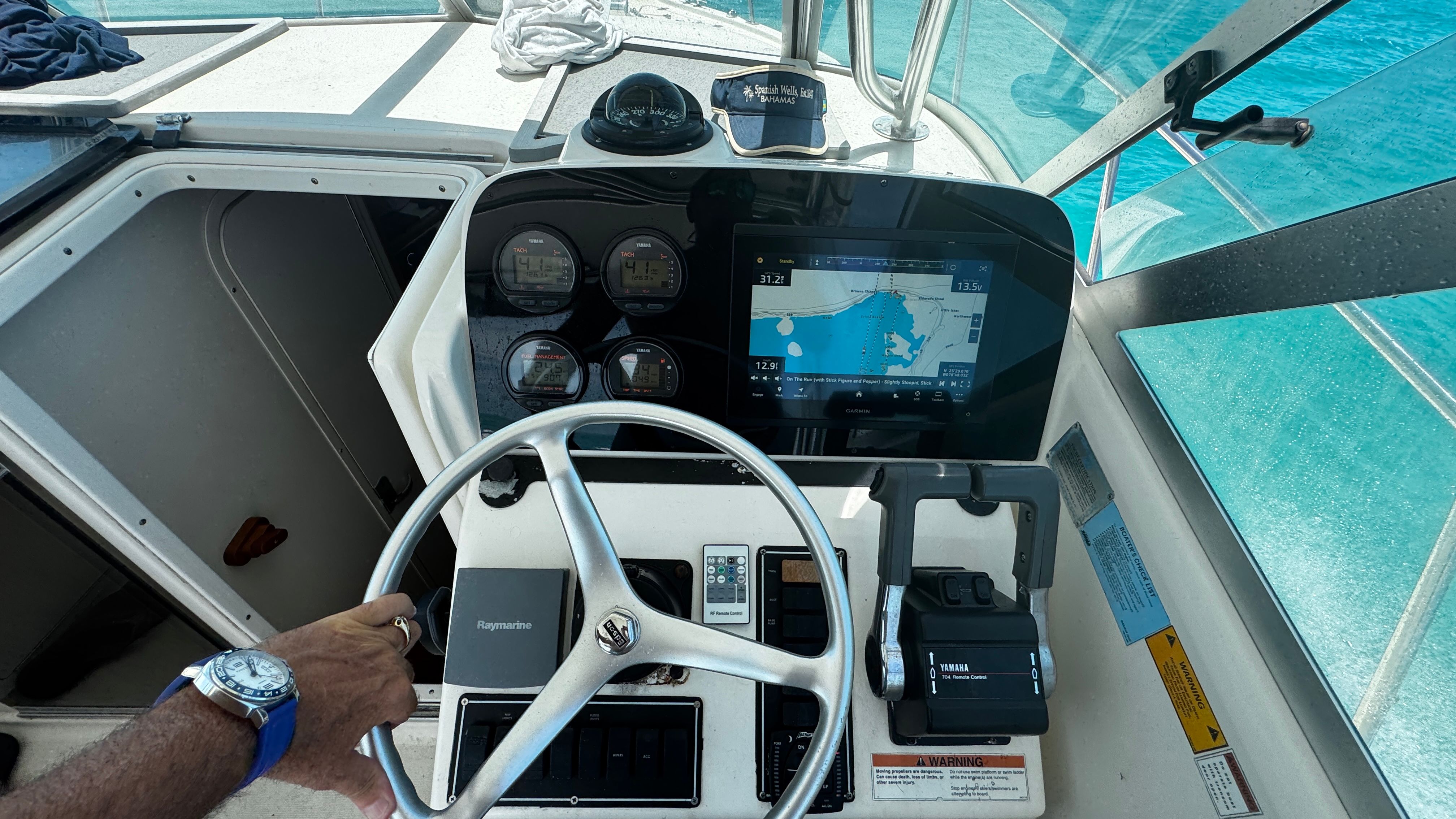 Helm of a 2003 Pursuit 3070 with navigation system and instruments.