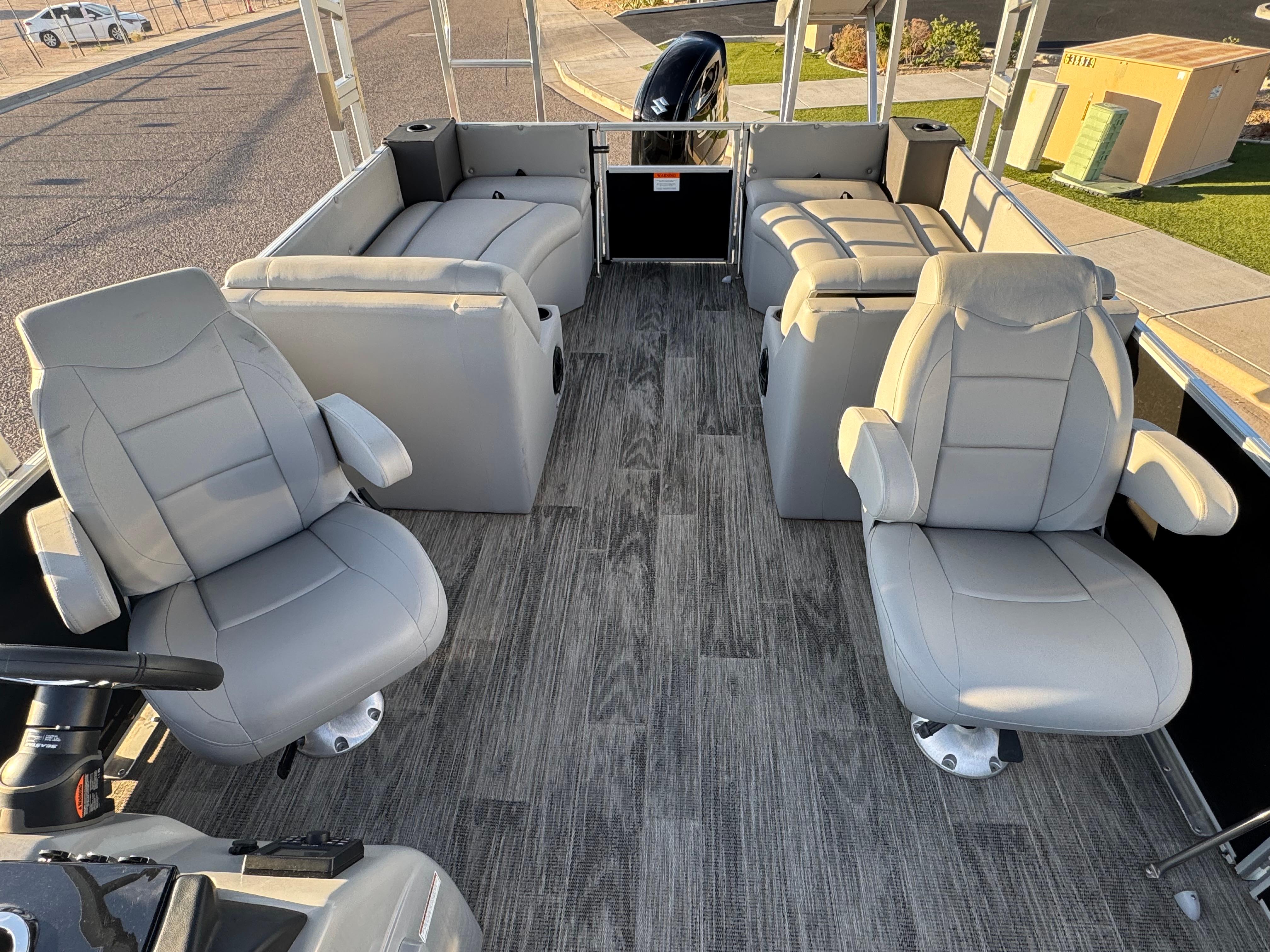 2024 Landau Island Breeze 252 pontoon boat interior with gray seating and wood-style flooring.