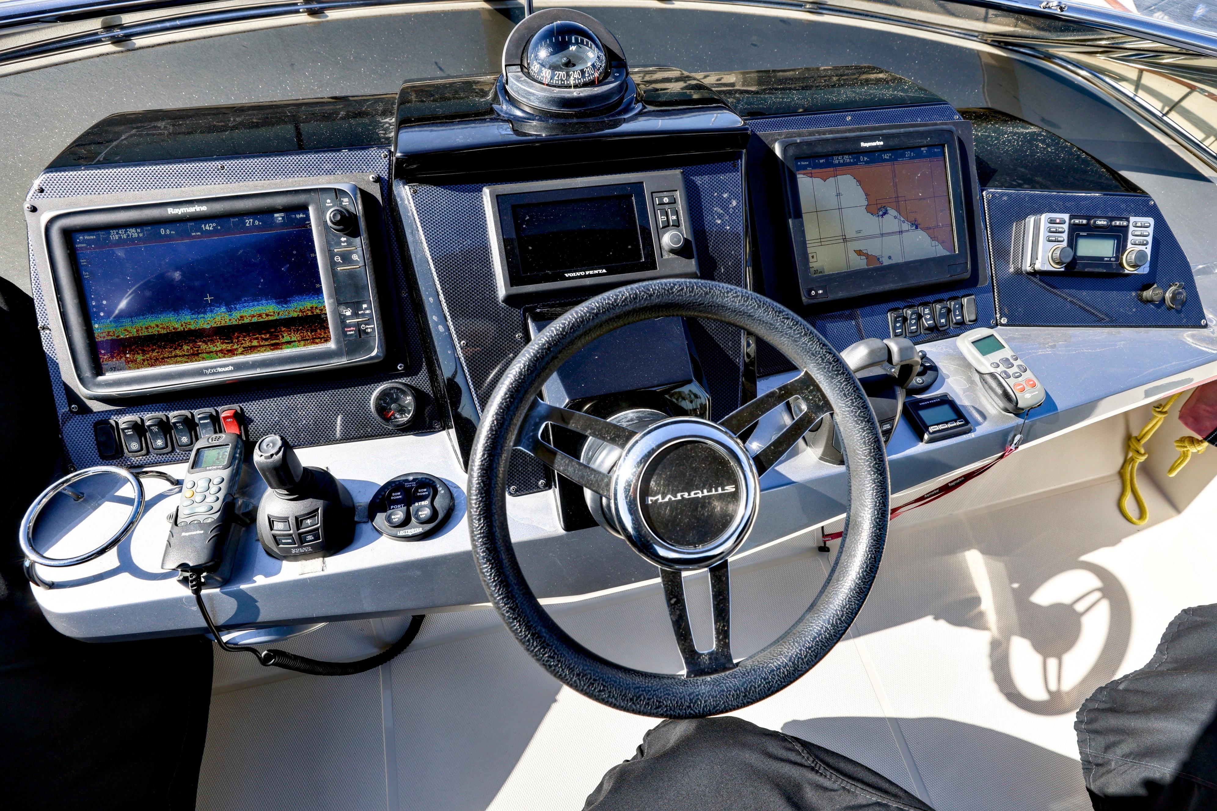Helm of 2013 Marquis 500 Sport Bridge with navigation and control systems.