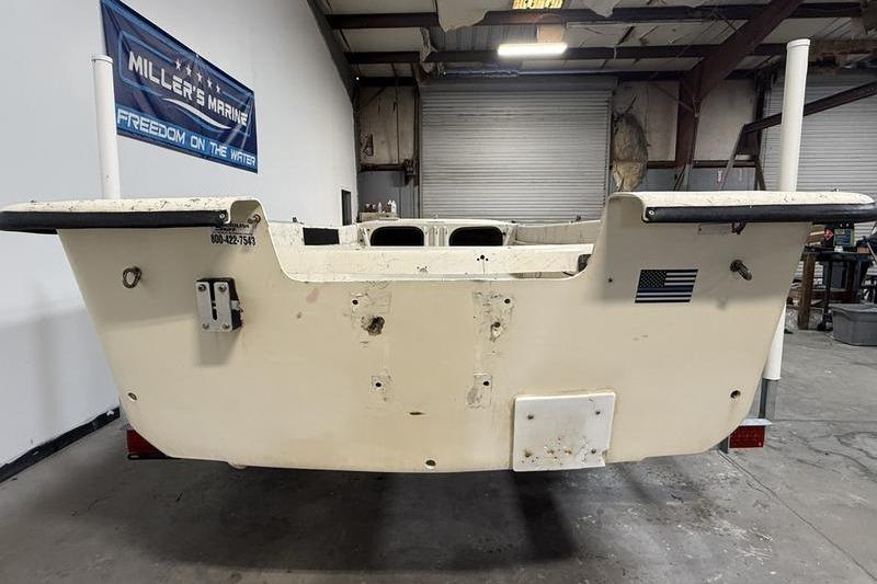1998 Carolina Skiff 1965 V boat in a warehouse, rear view.