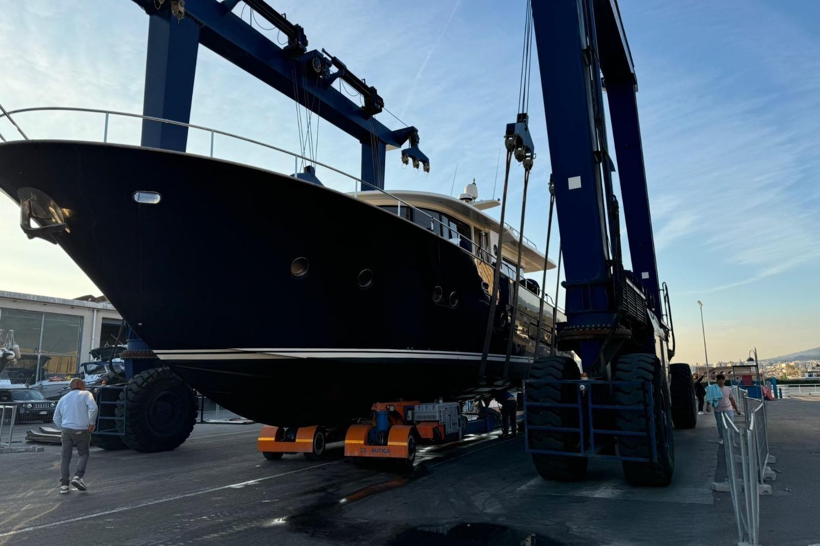 2008 Apreamare Maestro 65 yacht being lifted by a large crane at a shipyard.