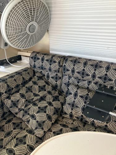 Interior of 1985 Cruisers Yachts 338 Chateau Vee with patterned upholstery and fan.