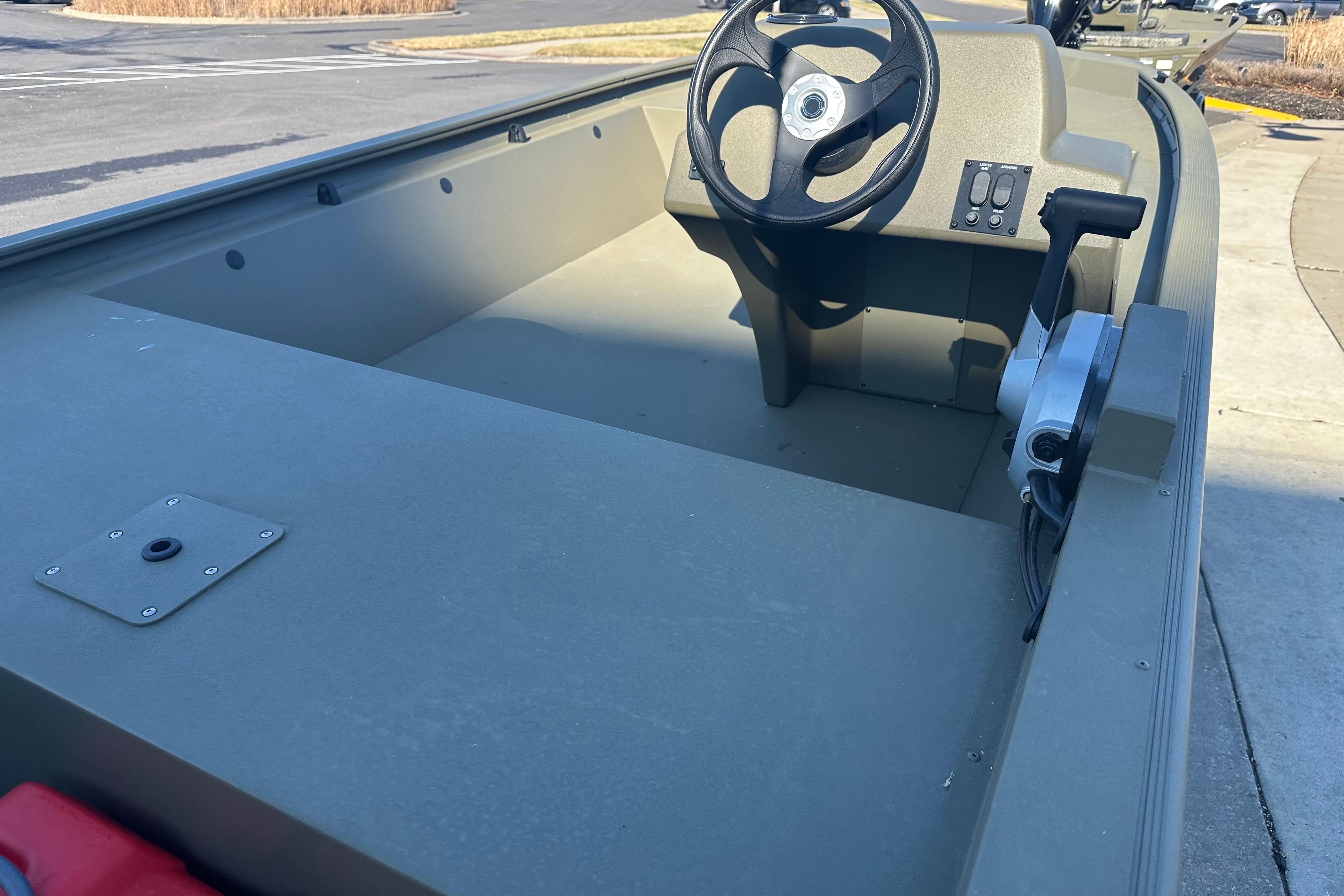 2026 Tracker Grizzly 1648 SC boat interior with steering wheel and control panel.