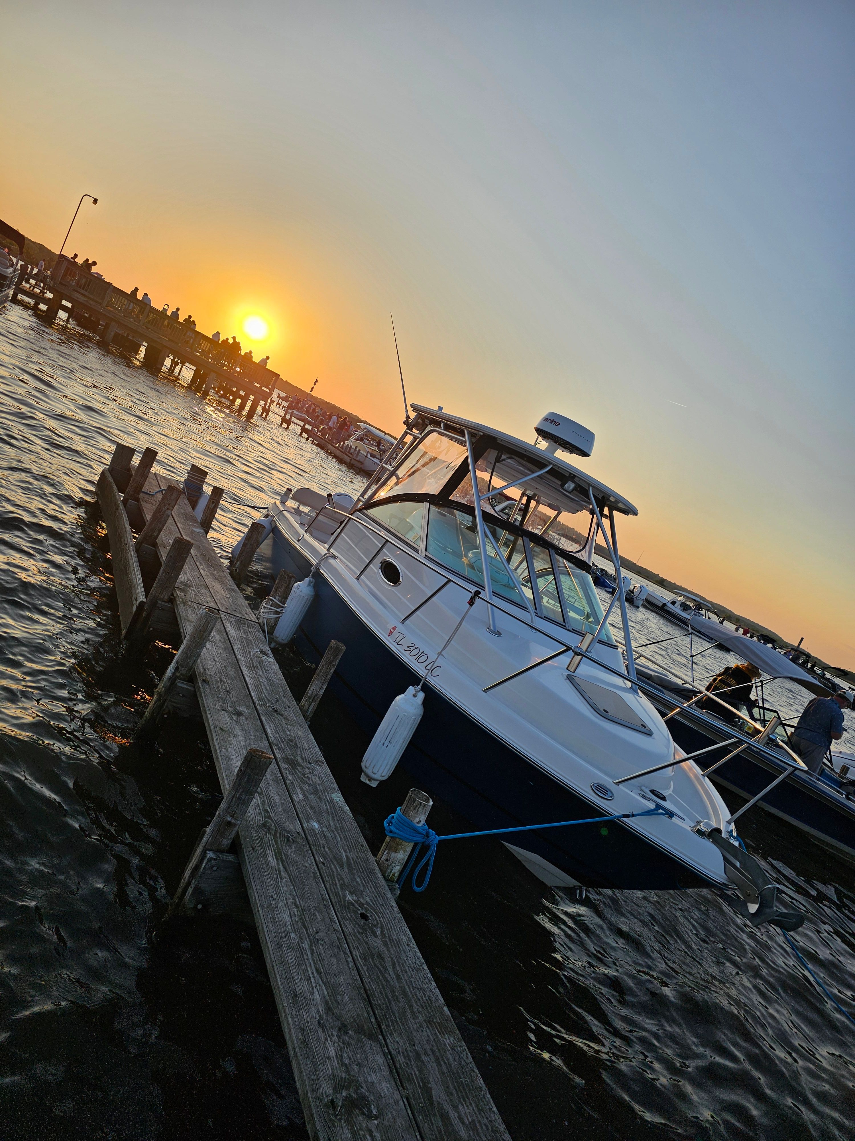 2005 Robalo R265 Walkaround boat docked at sunset.