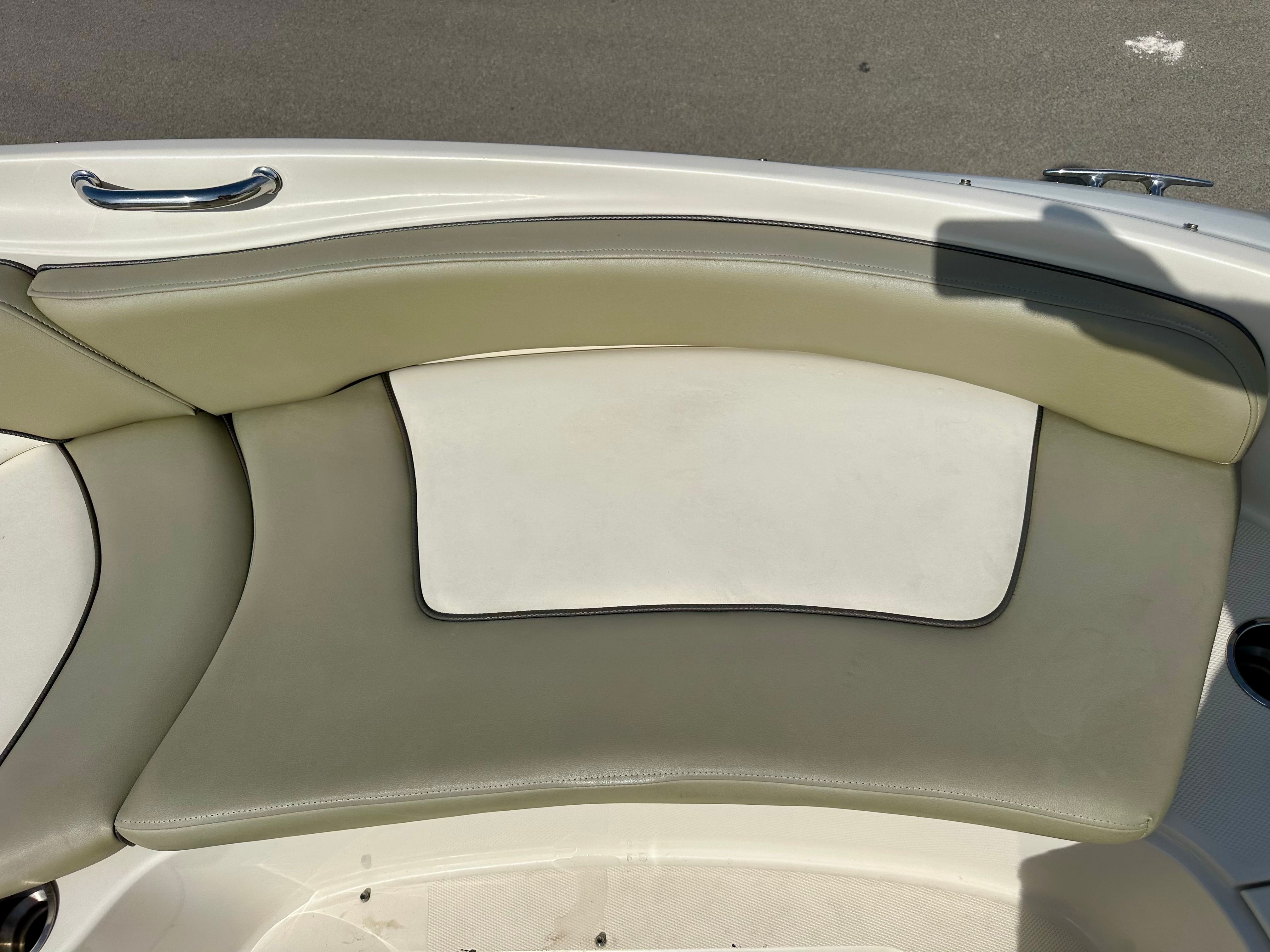 Interior of 2006 Sea Ray 240 Sundeck with beige upholstery.