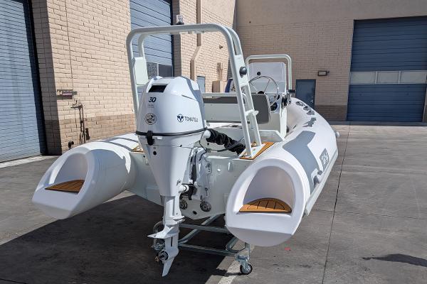 2025 Tide Craft San Juan 11 boat with outboard motor in a warehouse setting.