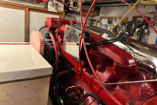 Engine room of a 1986 Kadey-Krogen 42 boat, featuring a red engine.