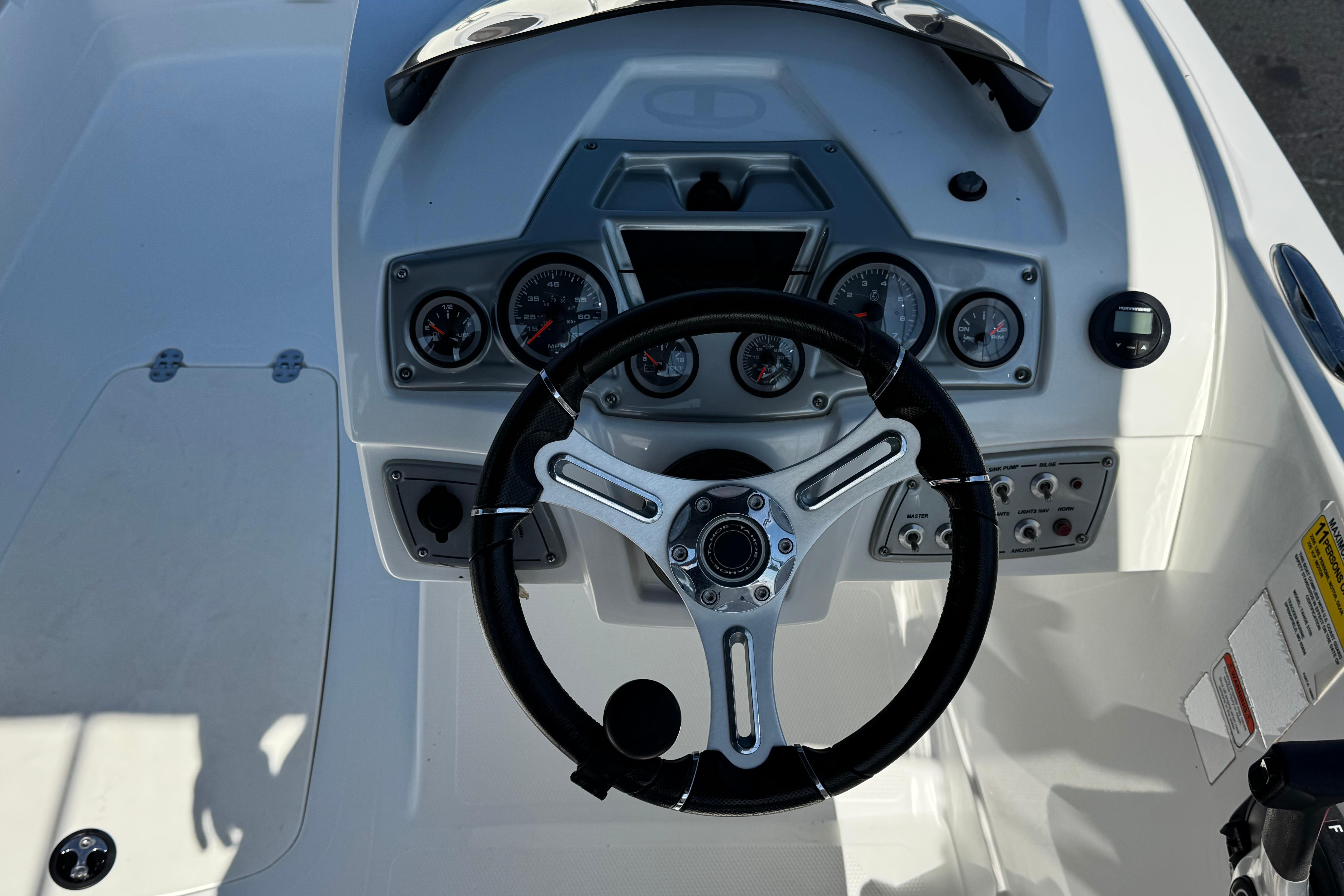 Steering console of a 2019 Tahoe 2150 boat with gauges and controls.