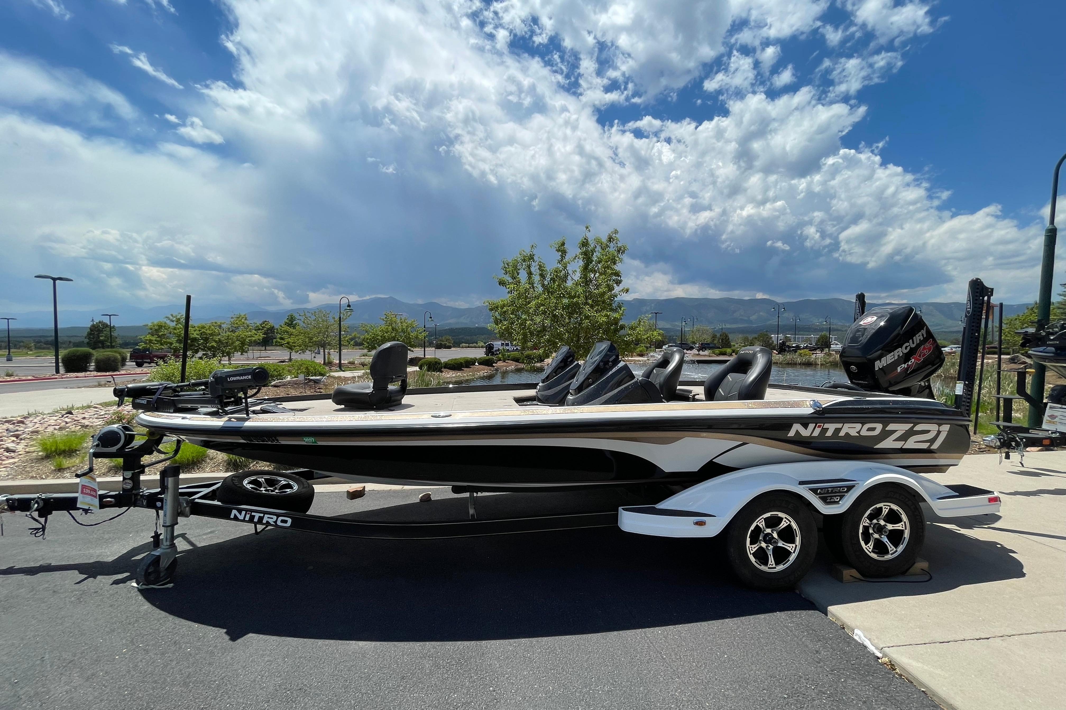 2016 Nitro Z21 boat on trailer under a partly cloudy sky.