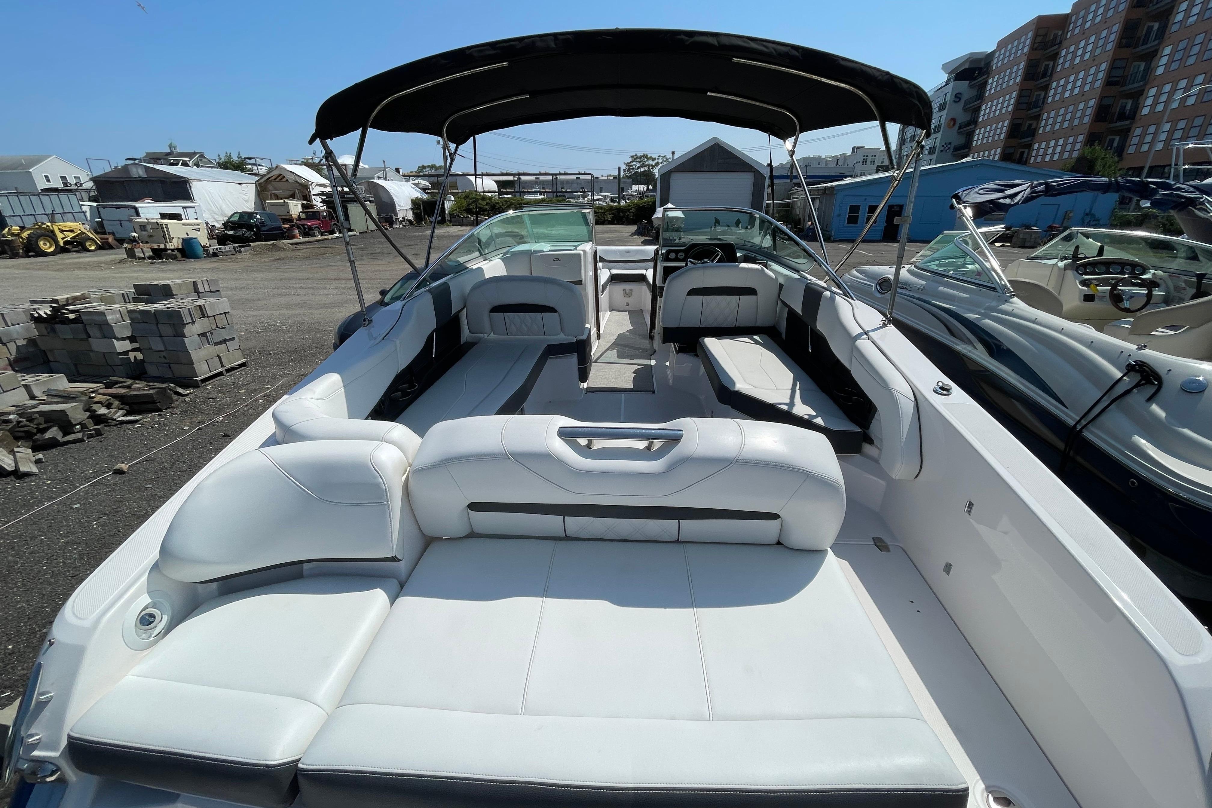 2018 Regal 26 OBX boat with spacious seating and canopy in a marina setting.