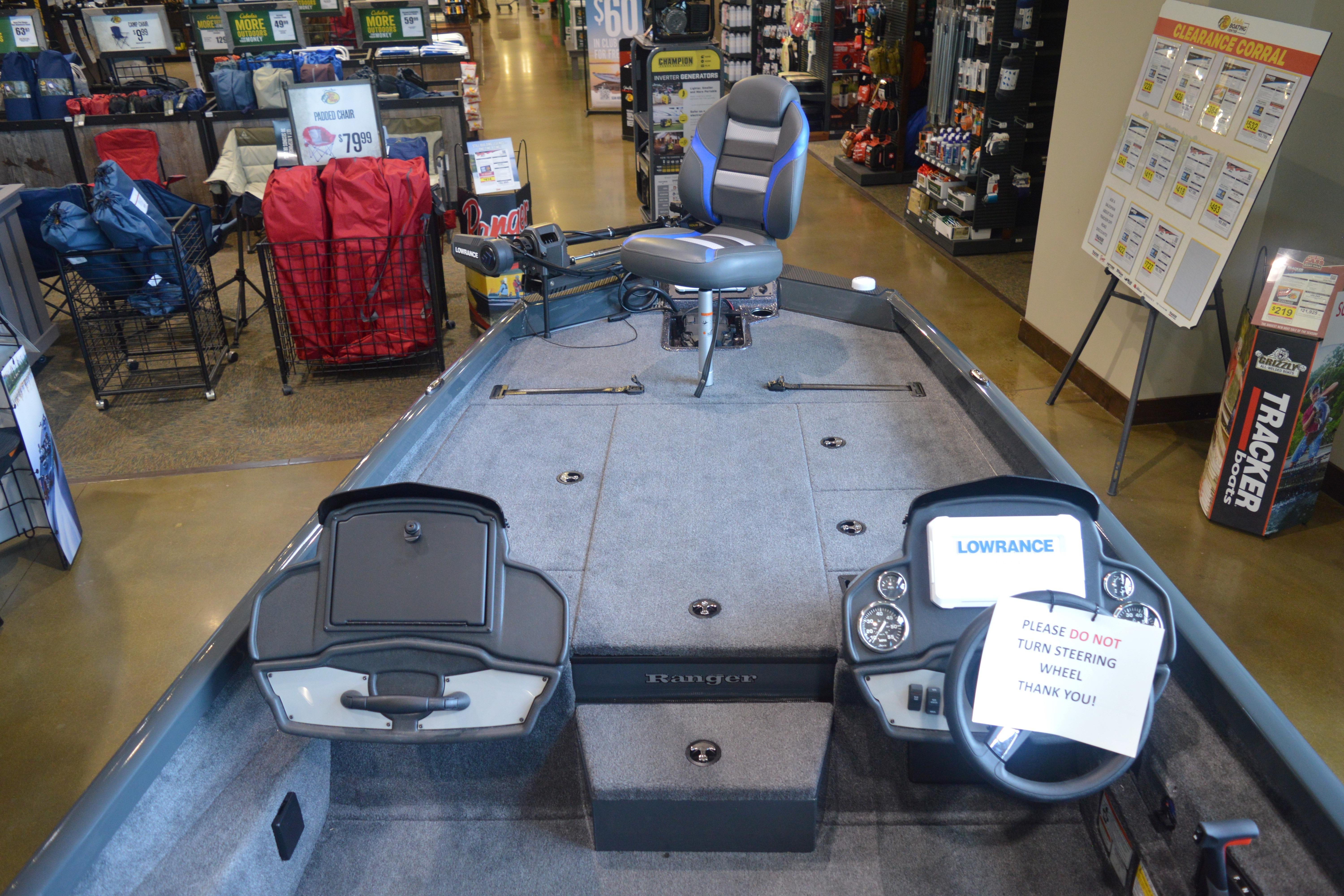 2026 Ranger RT188P boat interior in showroom, featuring steering console and seating.