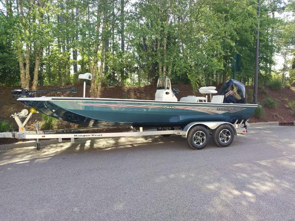 2024 Ranger RB210 boat on a trailer in a wooded area.