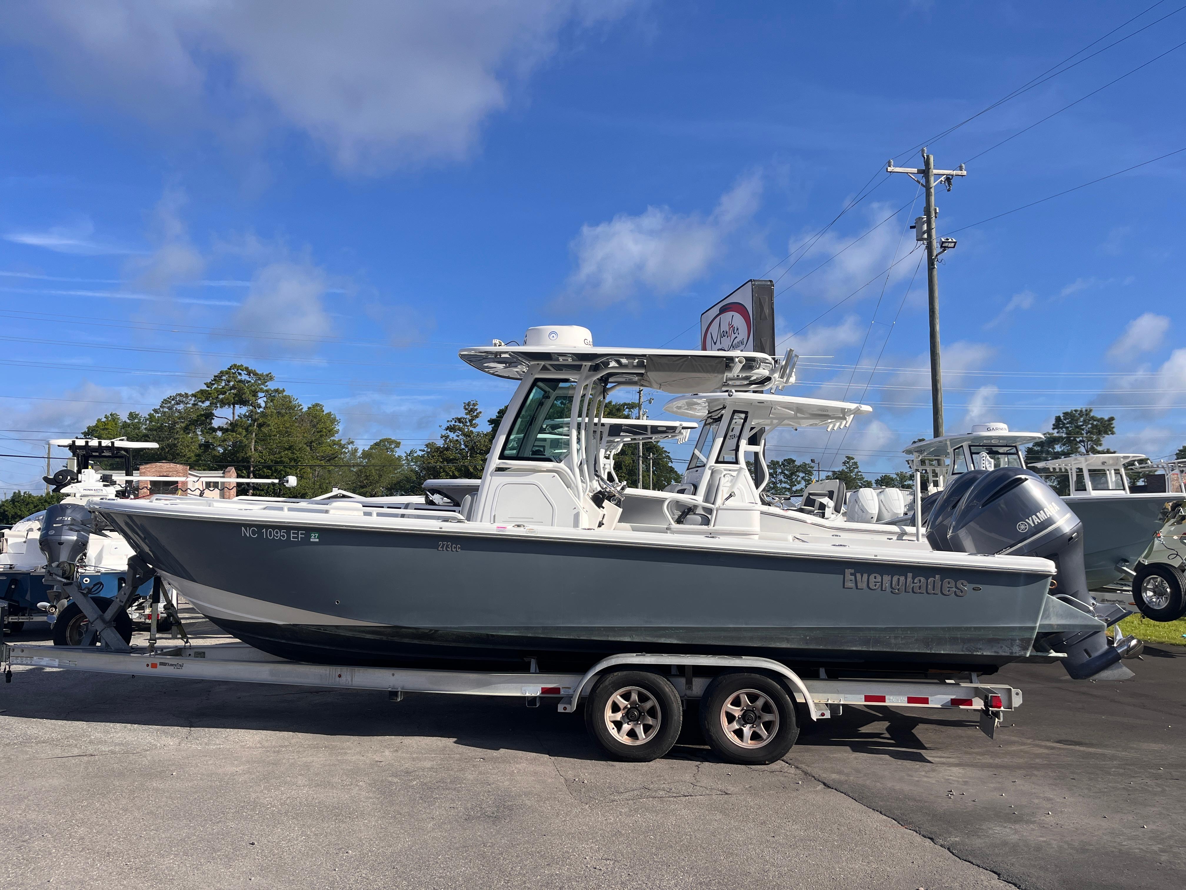2017 Everglades 273 Center Console boat on trailer under clear blue sky.