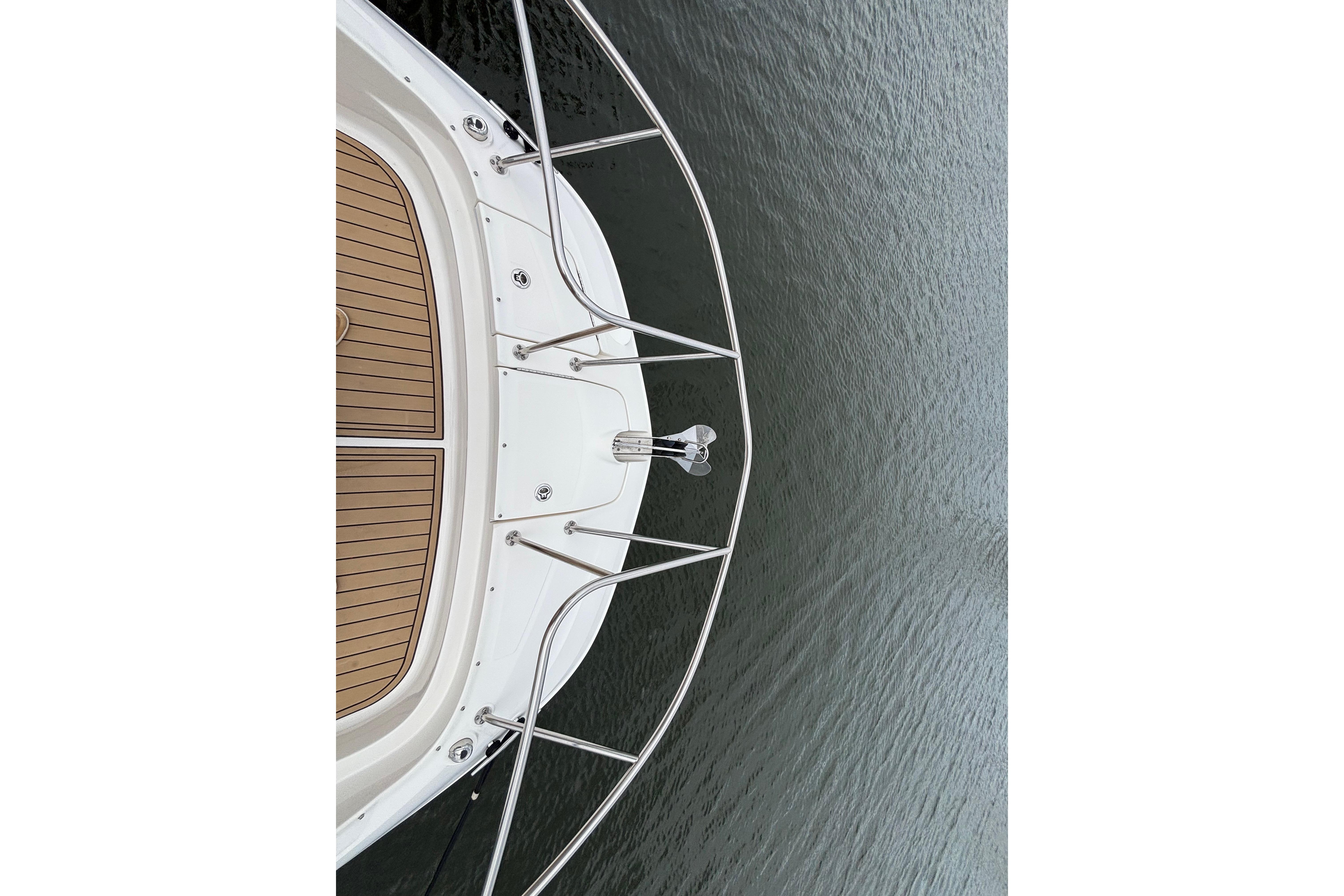 Bow view of 2021 Sea Ray Sundancer 320 Outboard on calm water.
