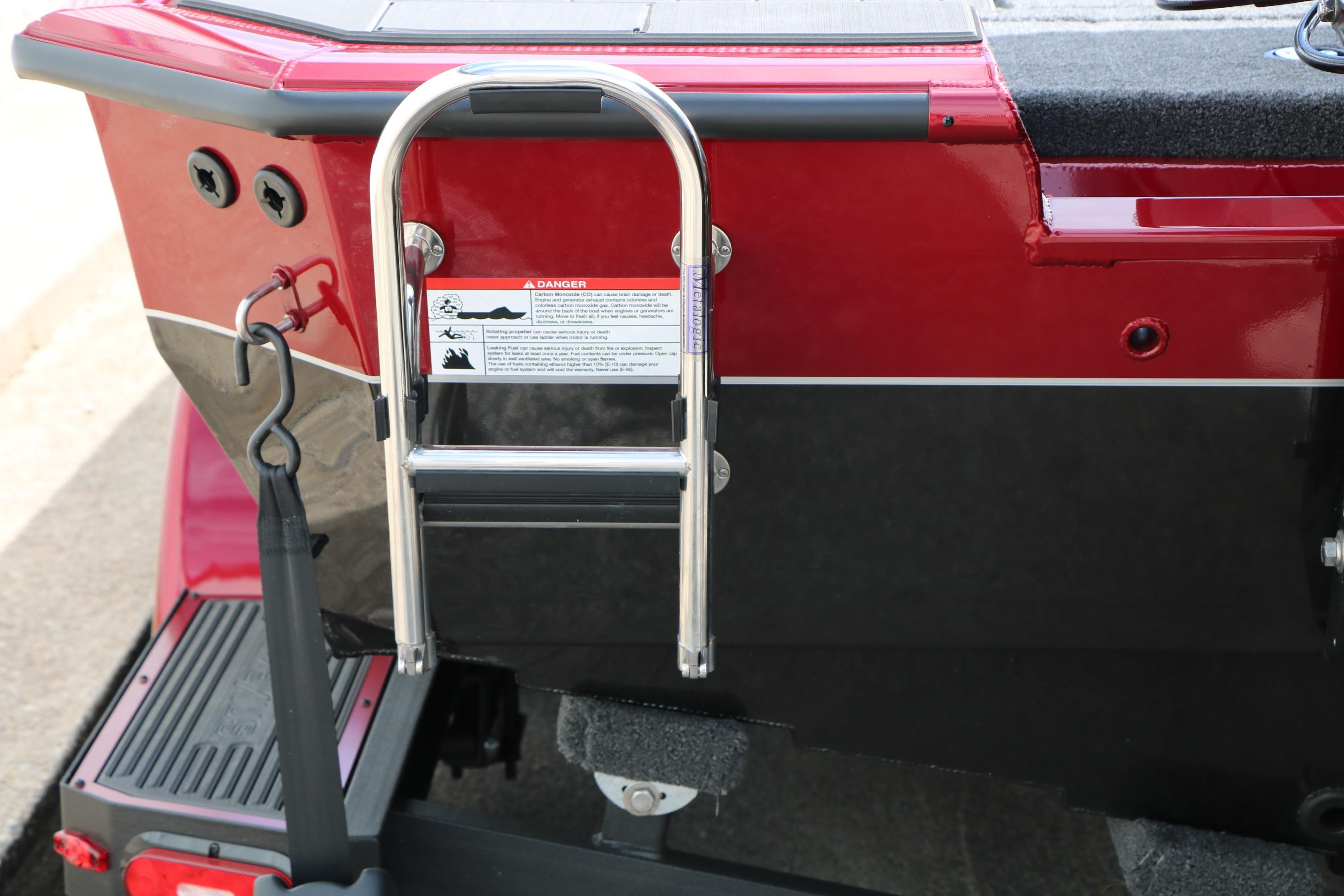 Rear view of 2026 Vexus AVX 1985s boat with ladder and warning label.