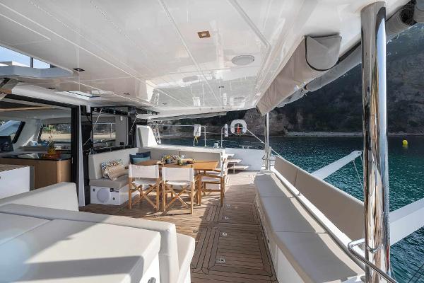 Luxurious 2025 Privilege Signature 580 yacht deck with elegant seating and dining area.
