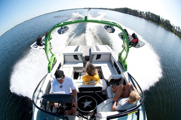 Manufacturer Provided Image: 2013 Nautique Super Air Nautique 230 on a lake with wakeboarders.