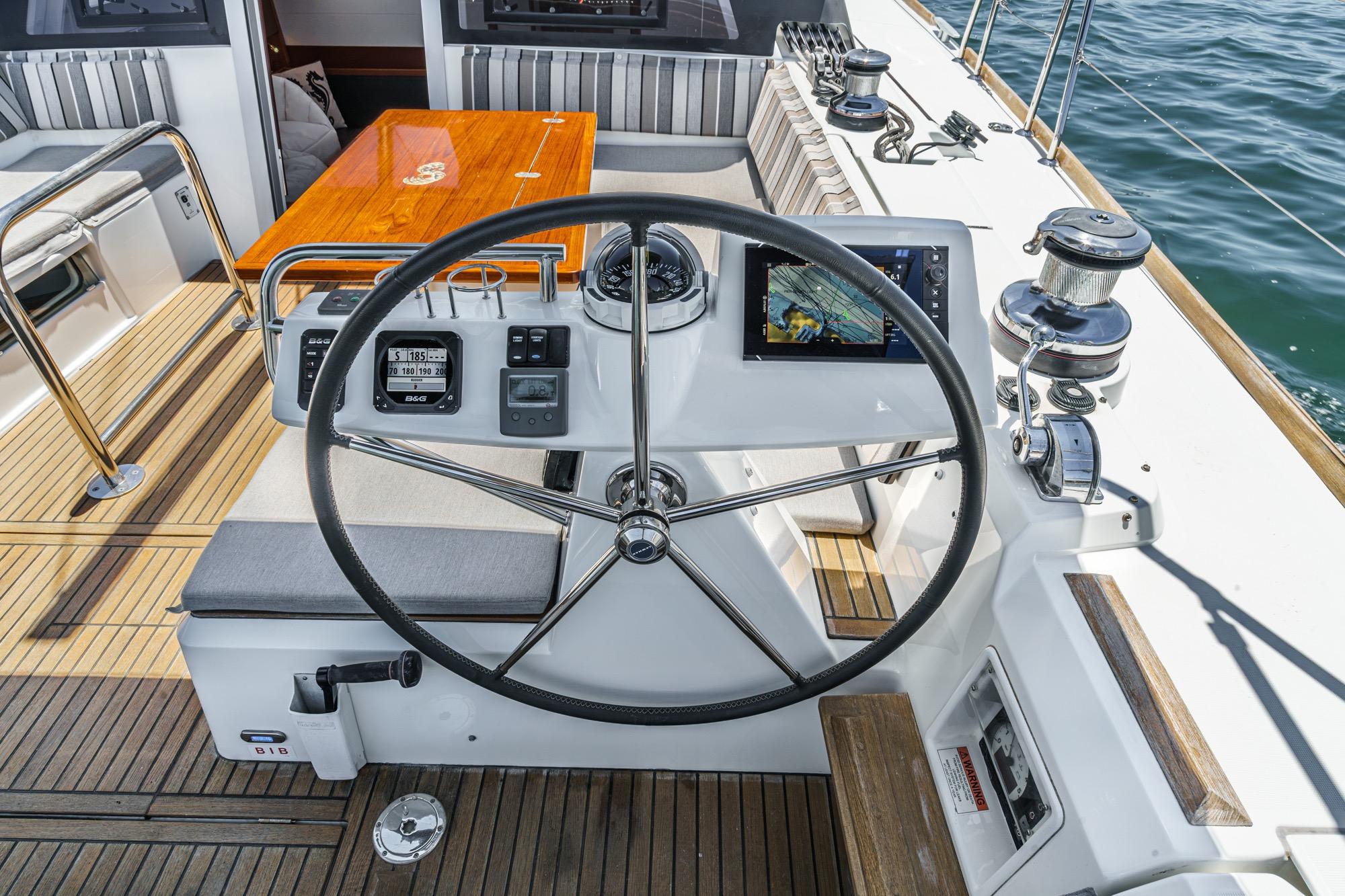 Cockpit of 2017 Beneteau Sense 50 yacht with steering wheel and navigation instruments.