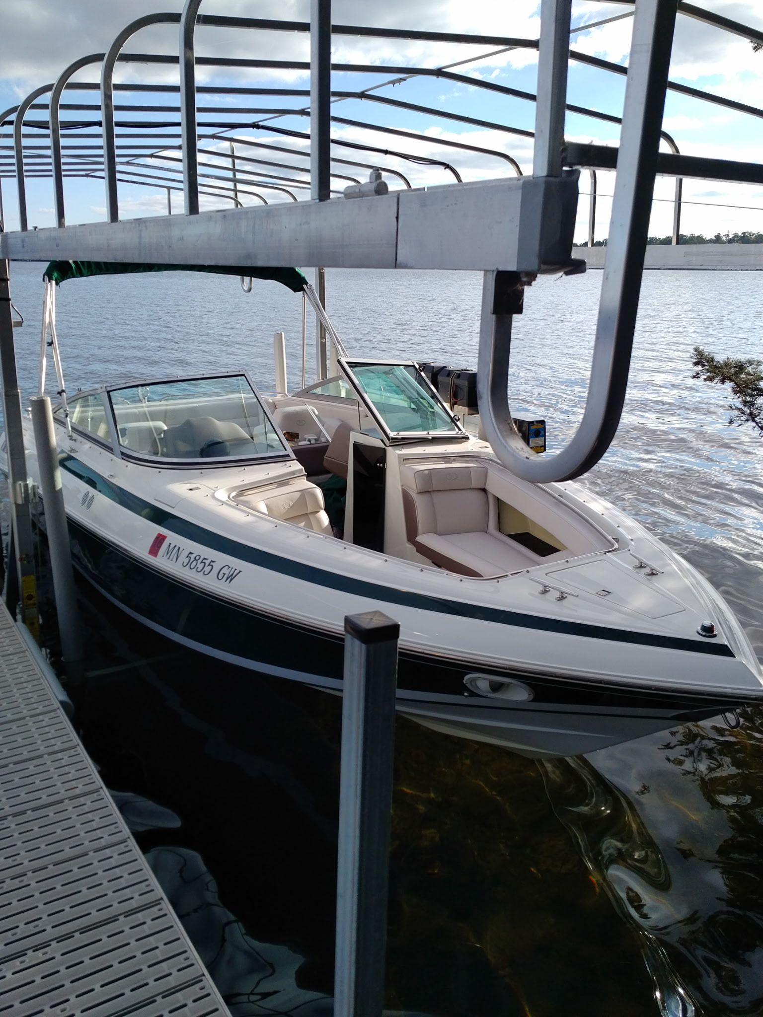 A 1995 Cobalt 222 boat is docked on the water.