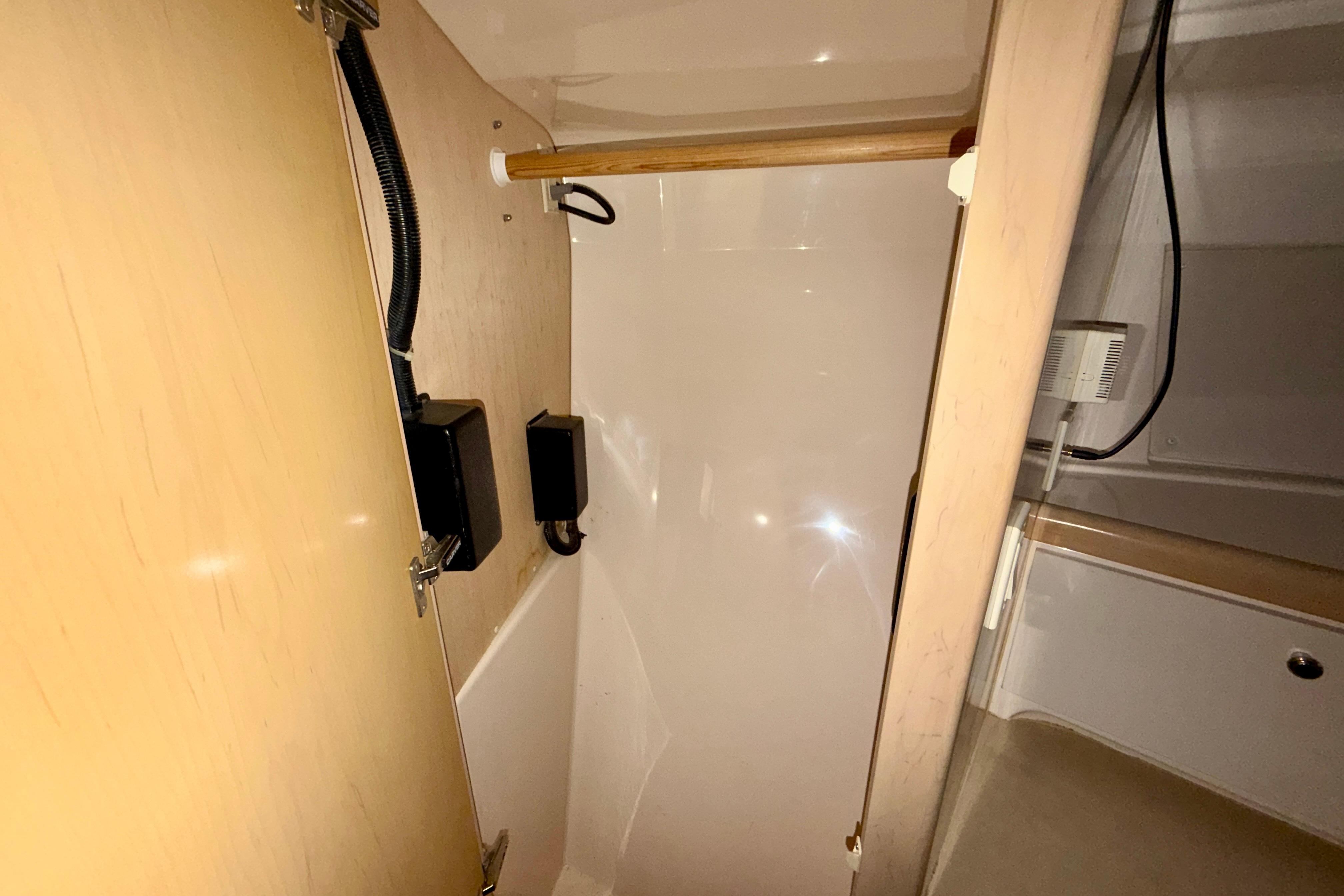 Interior view of a 2000 Carver 350 Mariner boat closet with wooden finish.