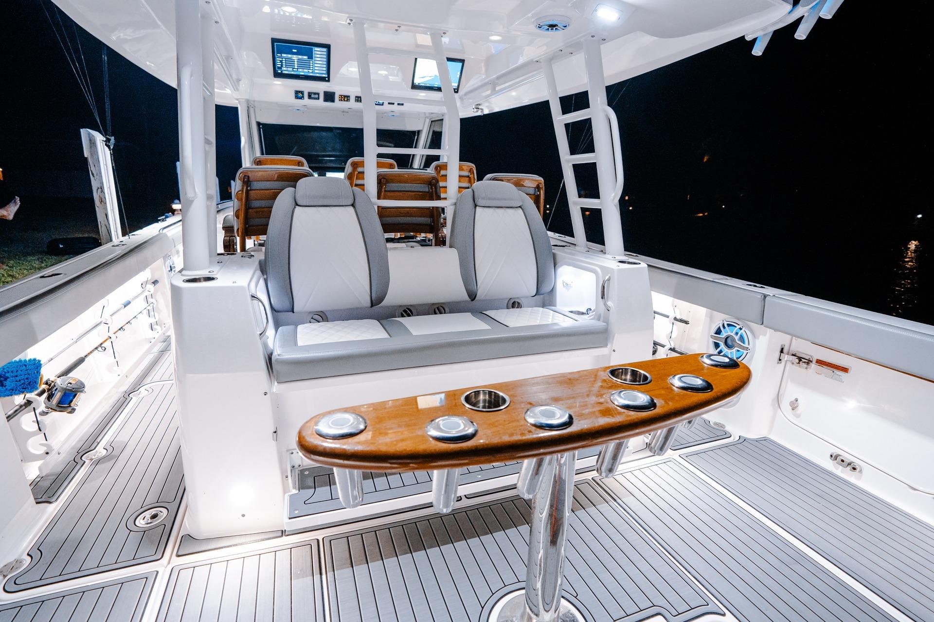 2026 Everglades 455 Center Console boat interior with seating and fishing rod holders.