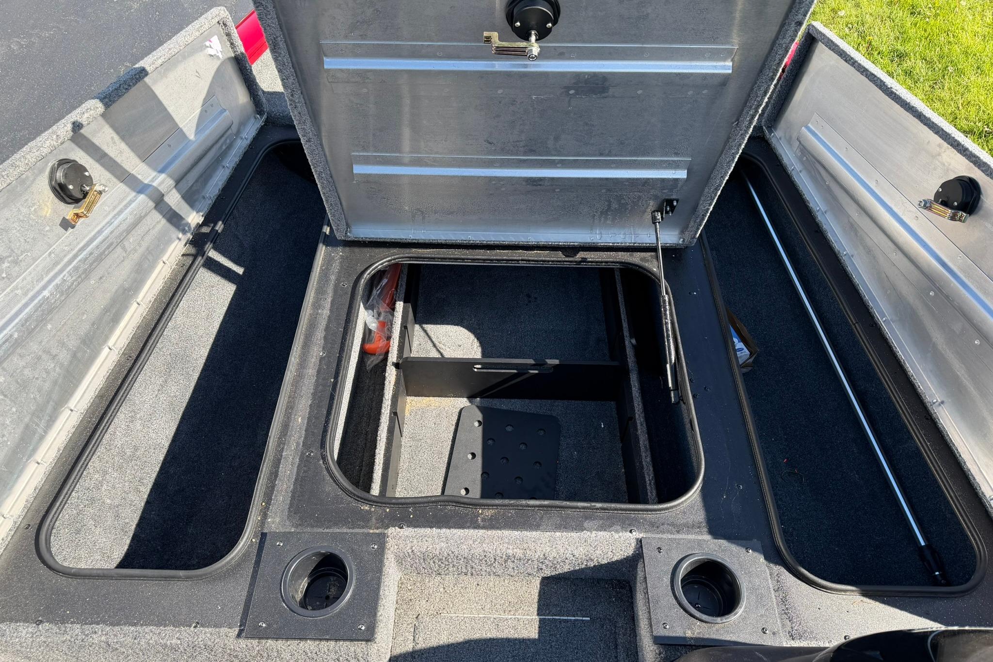 2024 Tracker Pro Team 175 TXW boat storage compartments open, showcasing interior space.