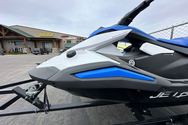 A Yamaha WaveRunner Jetblaster in black and blue on a trailer in front of a building.
