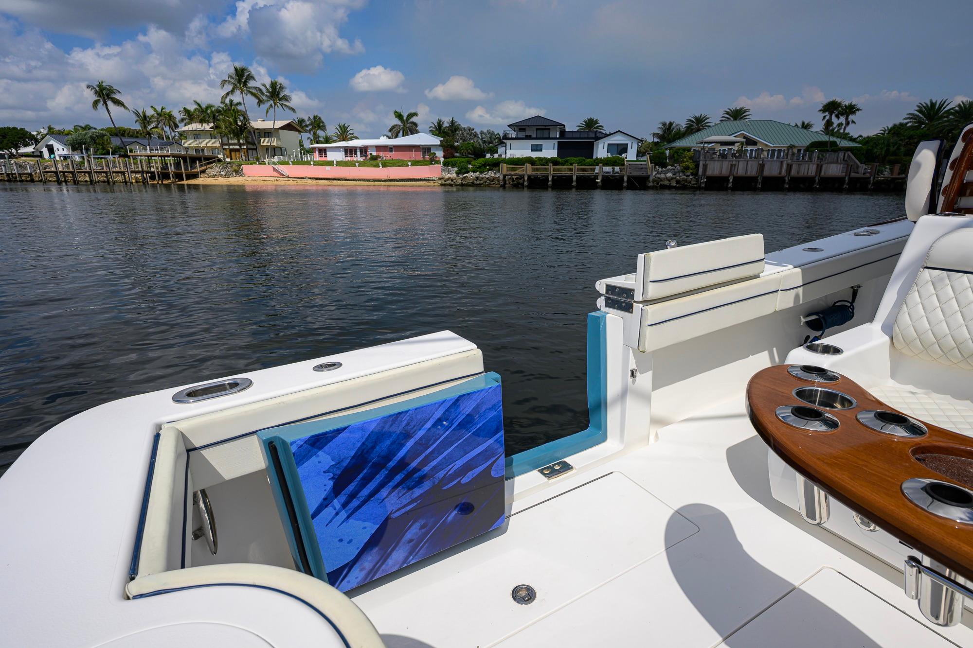 2020 Valhalla Boatworks V-41 on calm water, featuring luxurious seating and cup holders.