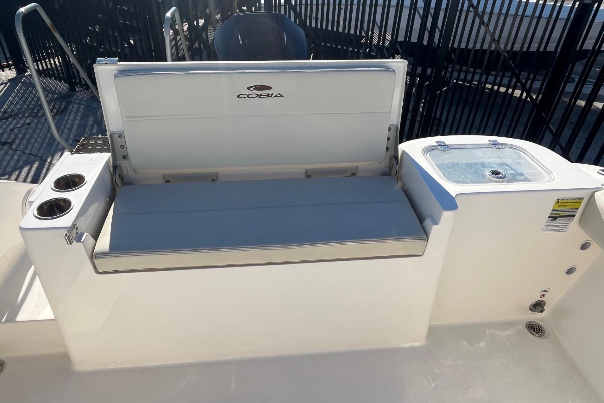 2023 Cobia 220 Dual Console boat interior with seating and cup holders.