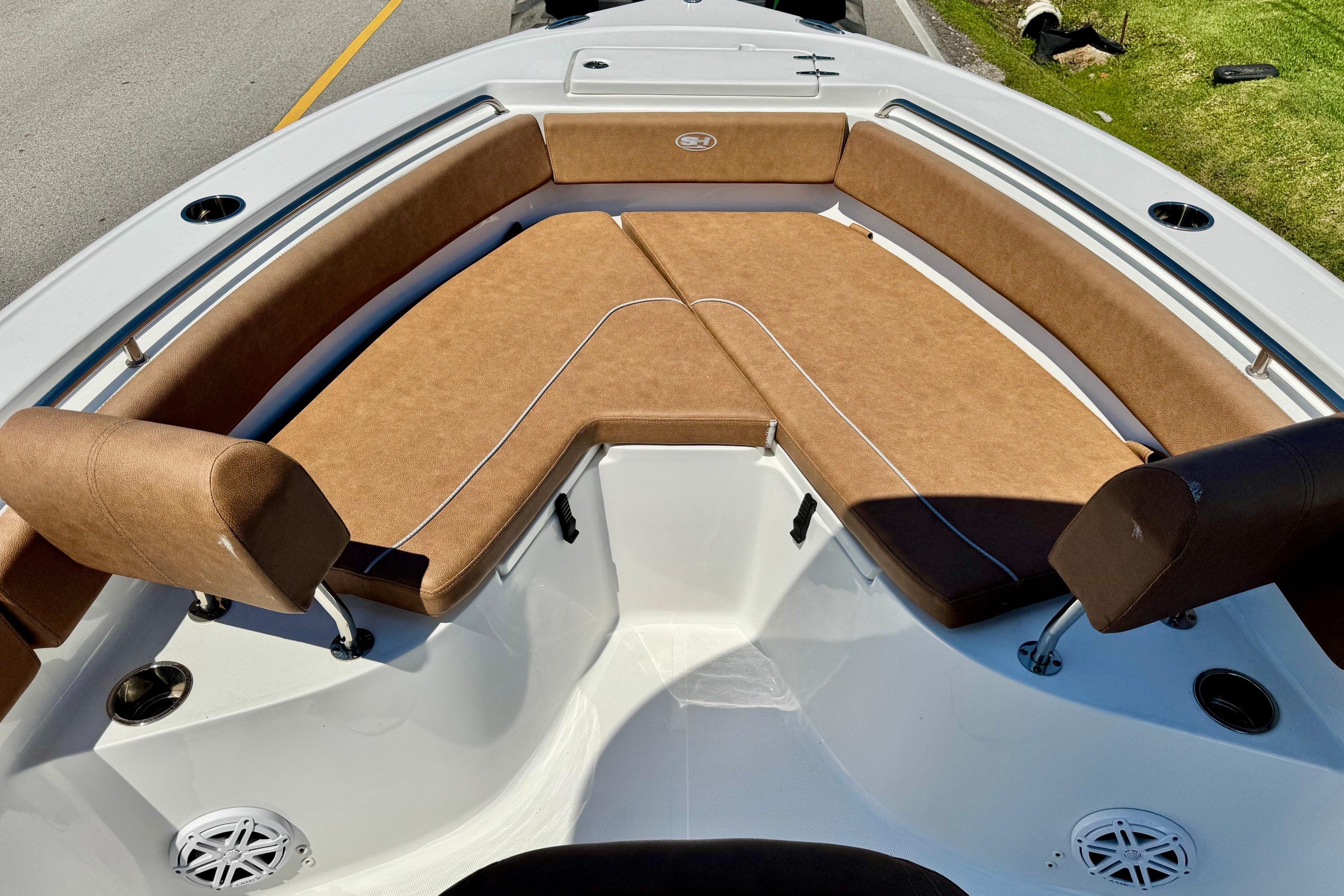 2025 Sea Hunt Ultra 219 boat with brown cushioned seating and sleek design.