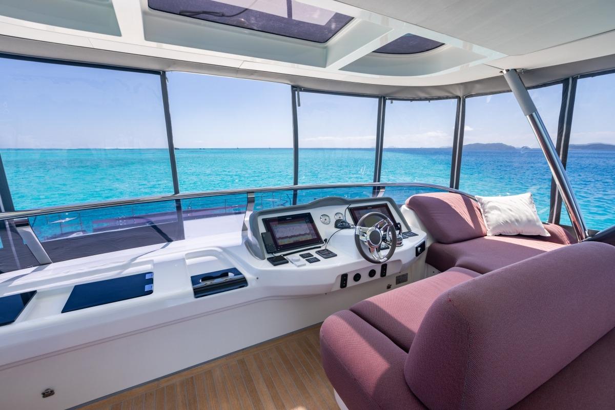 Luxurious 2020 Lagoon Sixty7 yacht interior with panoramic ocean views and modern helm.