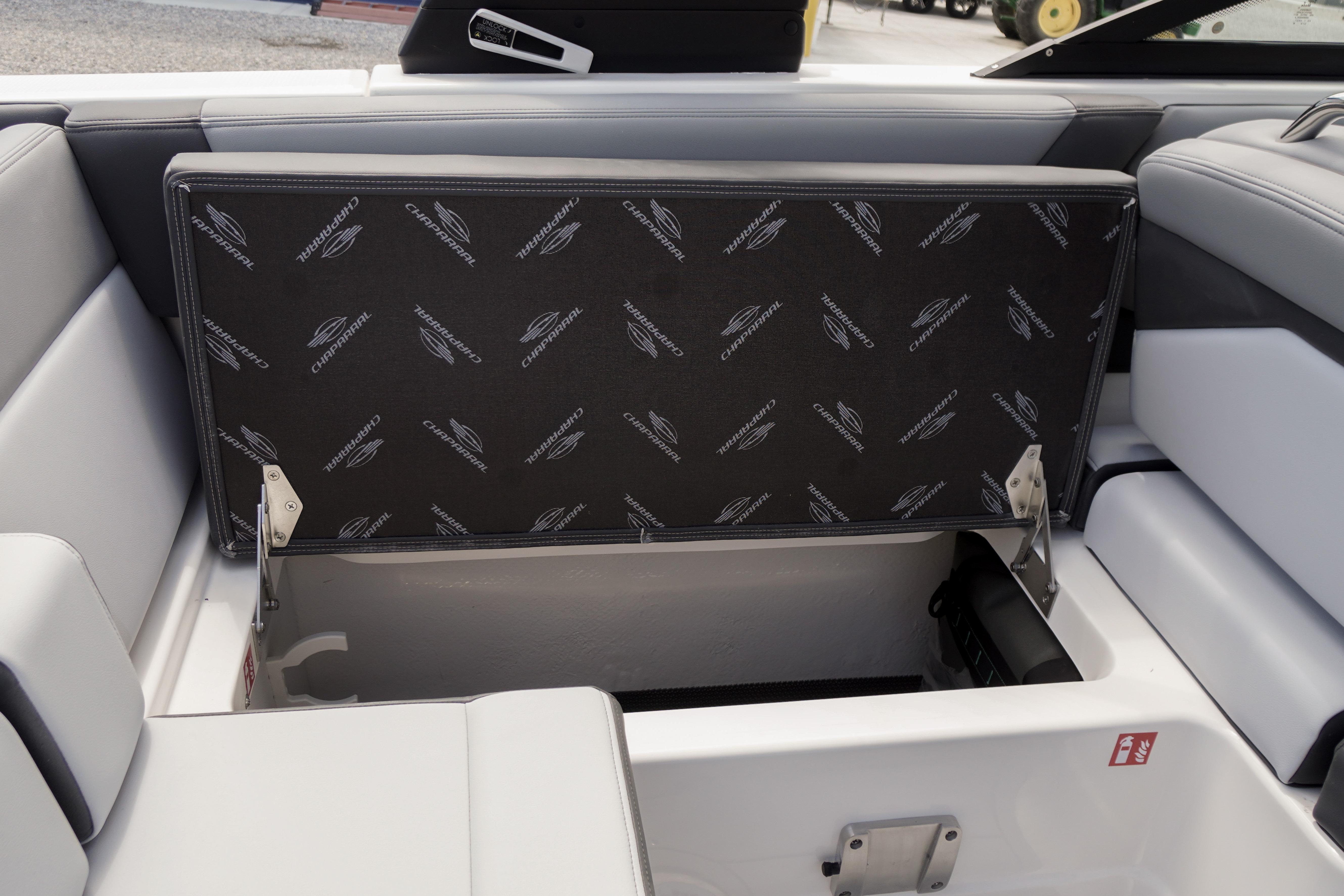 2026 Chaparral SSX 4 boat storage compartment with branded upholstery and open lid.
