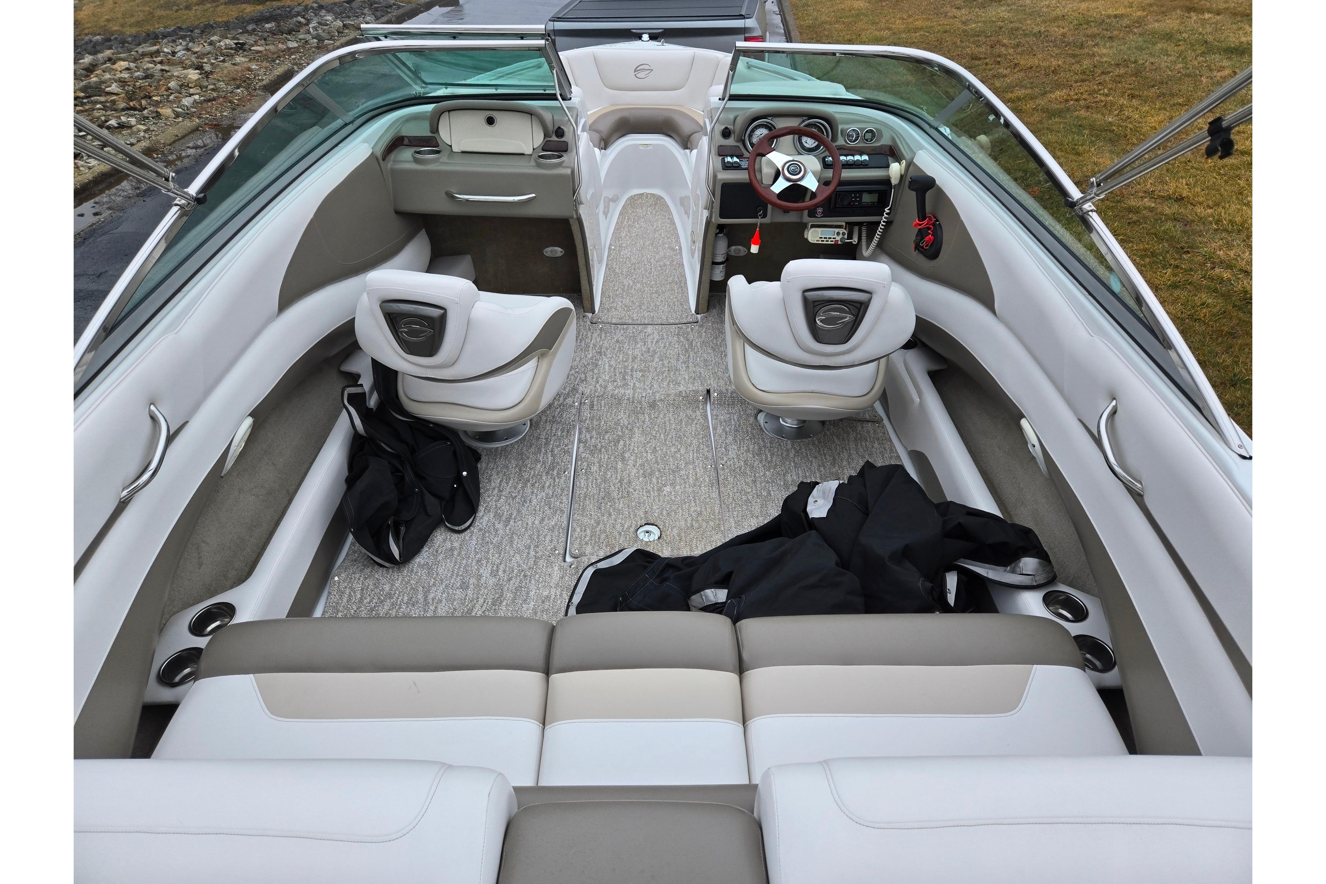 2012 Crownline 235 SS boat interior with beige seating and modern dashboard.