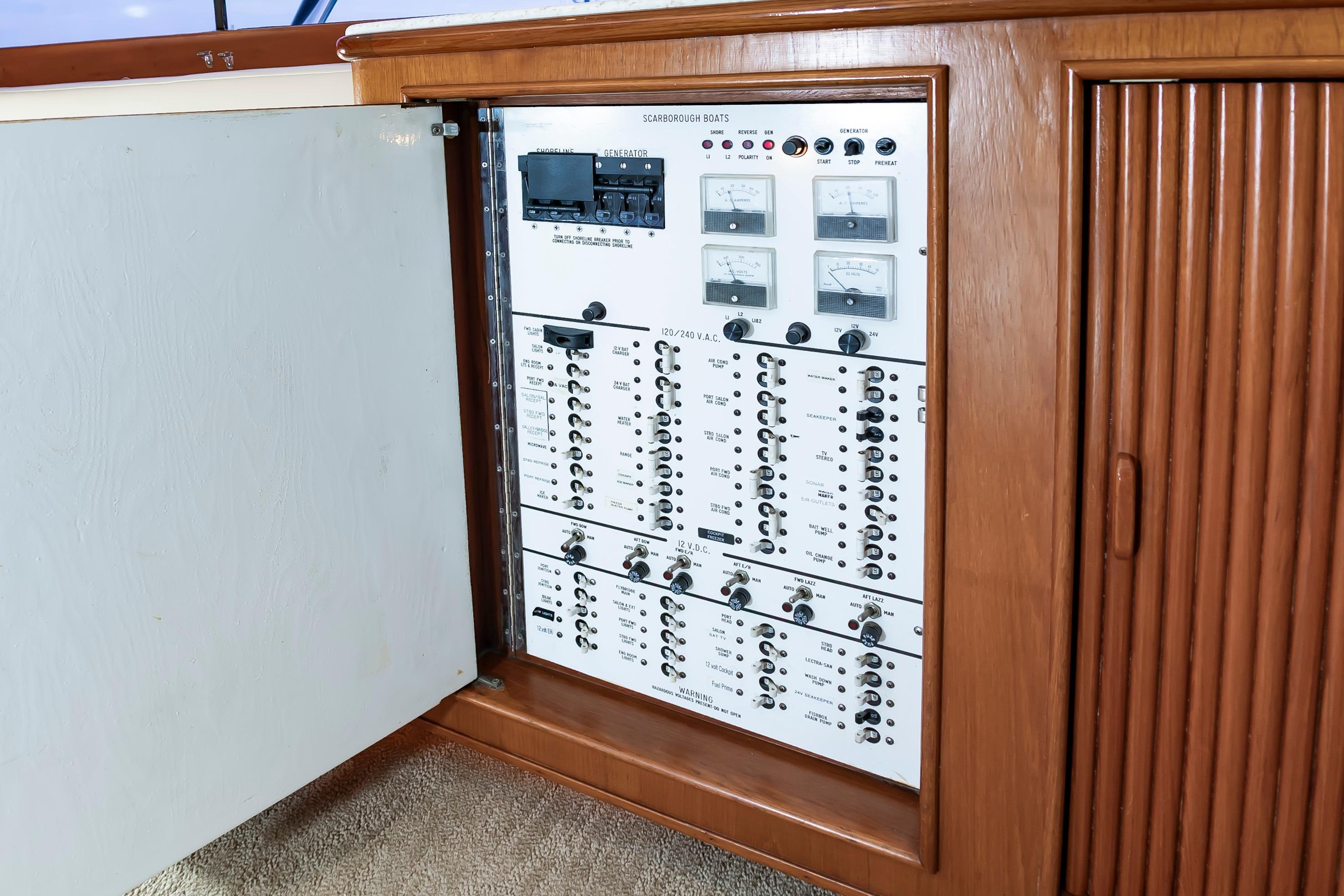 Electrical panel inside 1993 Custom Carolina Scarborough 56 Convertible yacht, showcasing controls and meters.